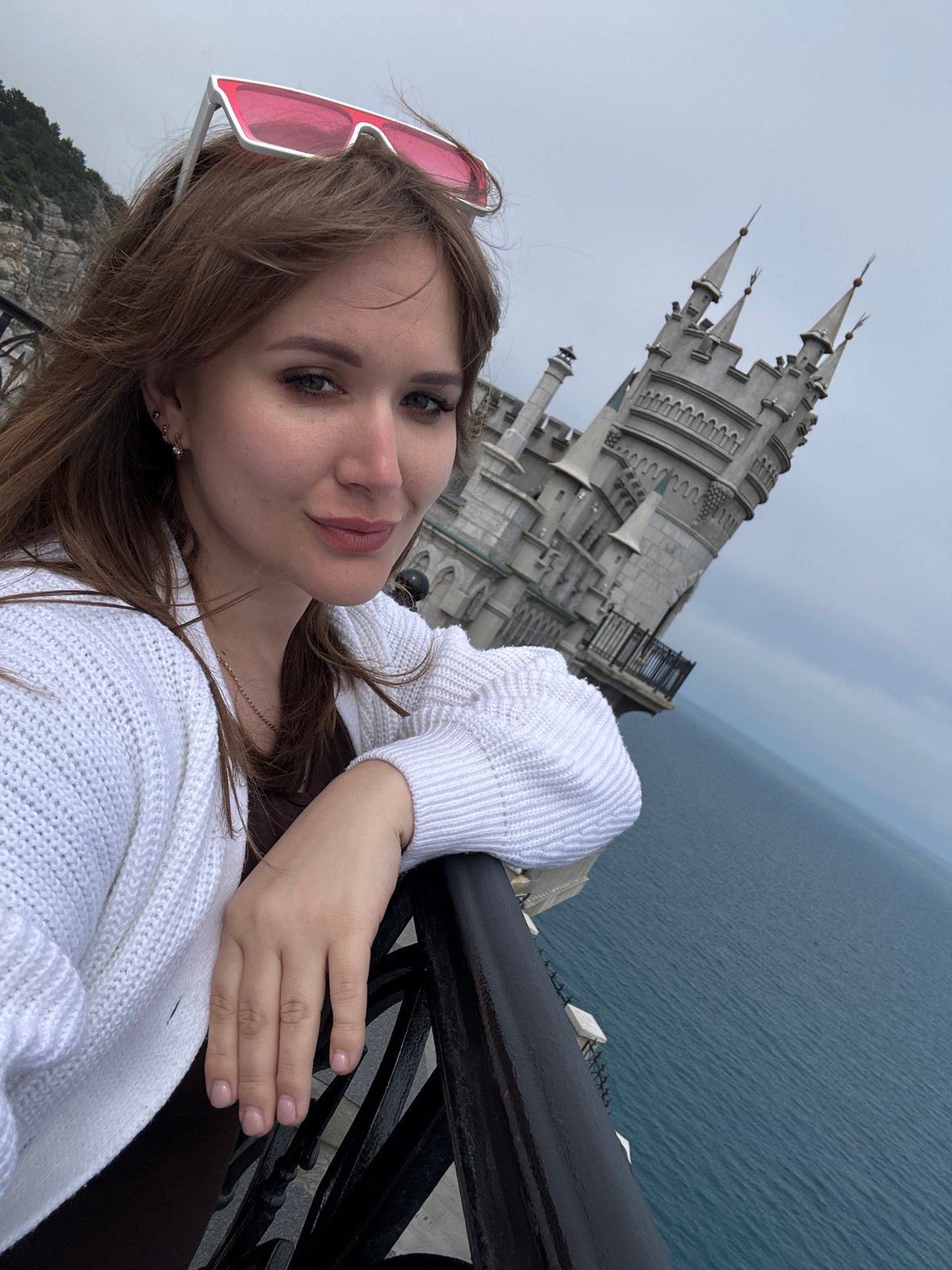 Tourist photographs Swallow's Nest castle and coastal scenery in Ukraine