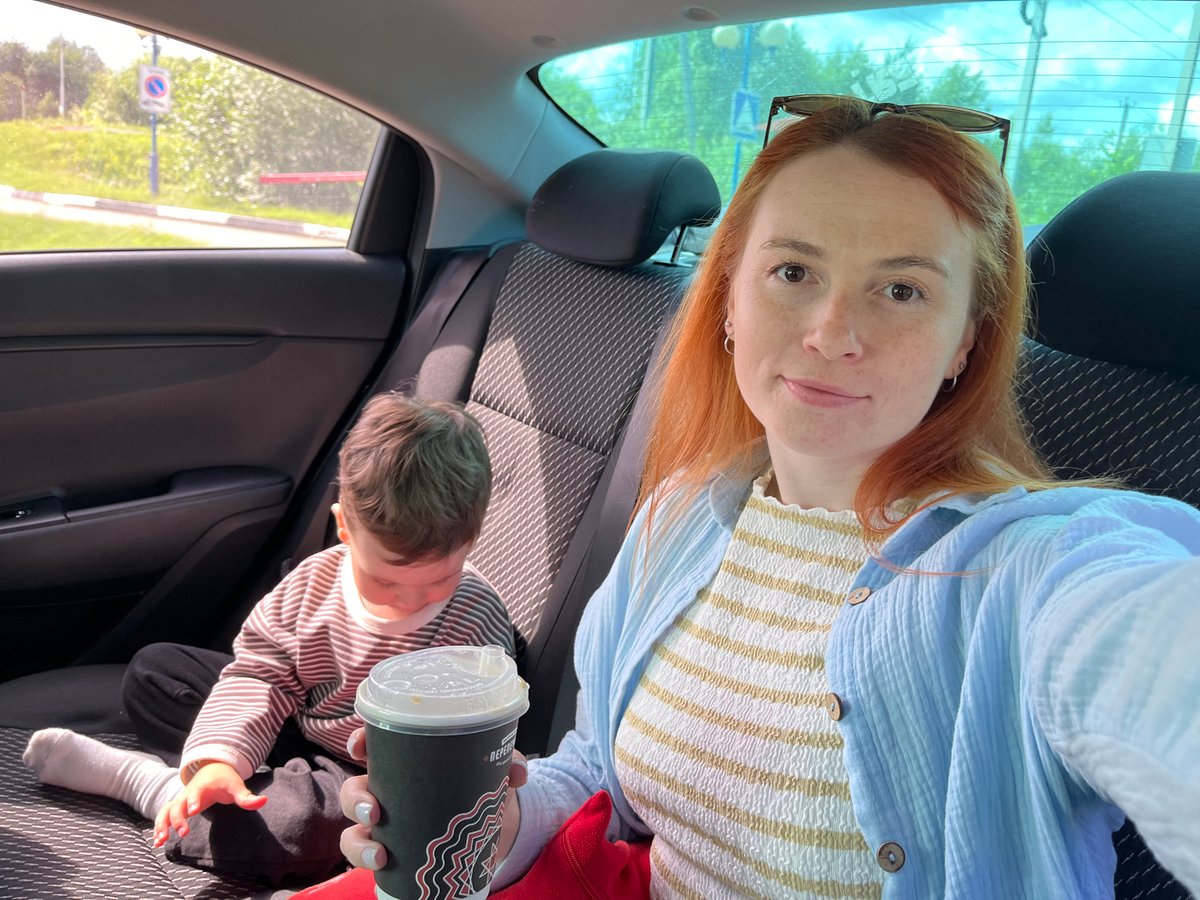 Backseat selfie with coffee, somewhere in rural Russia