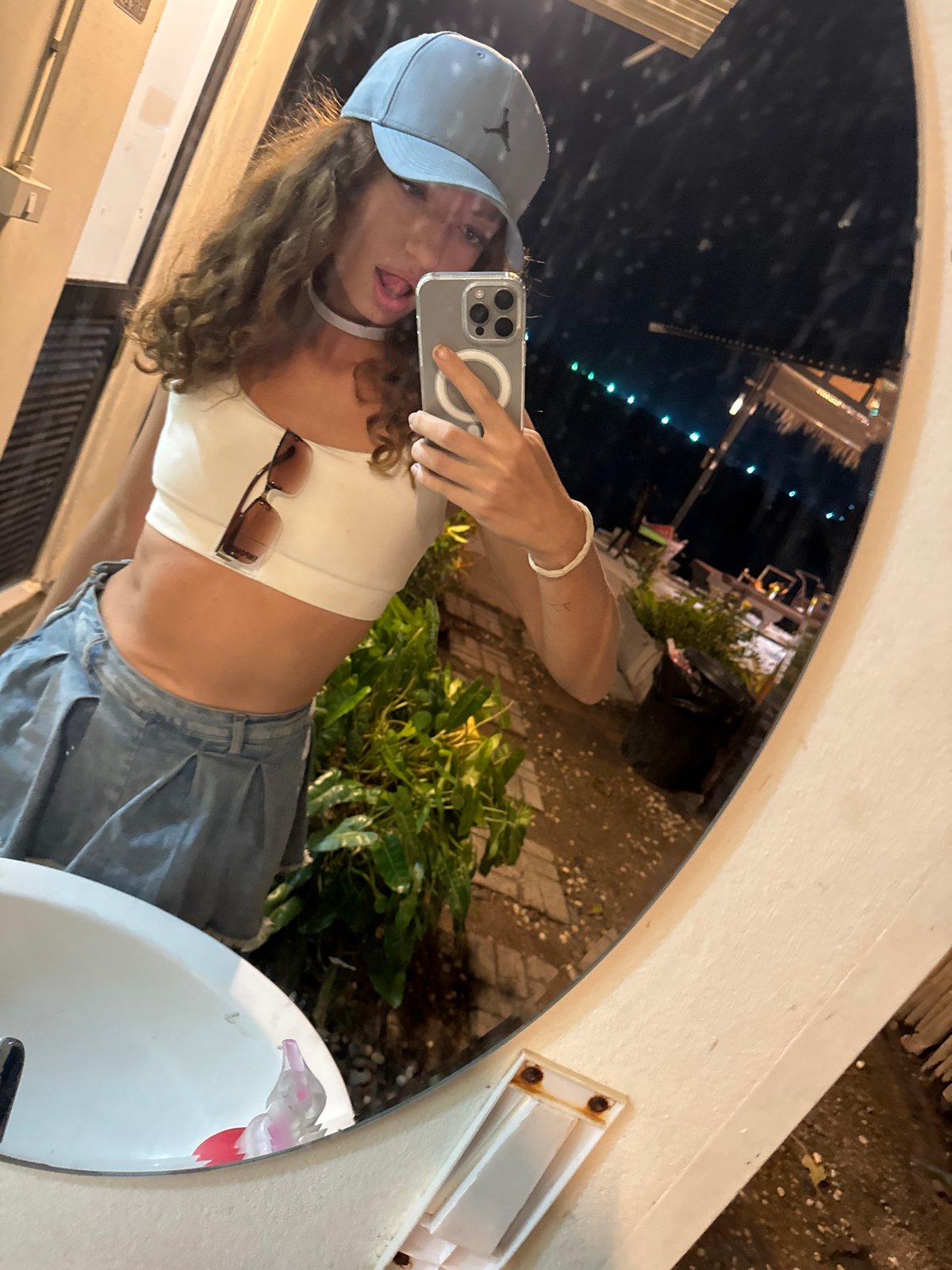 Woman takes mirror selfie in Baan Bang Rak, Thailand