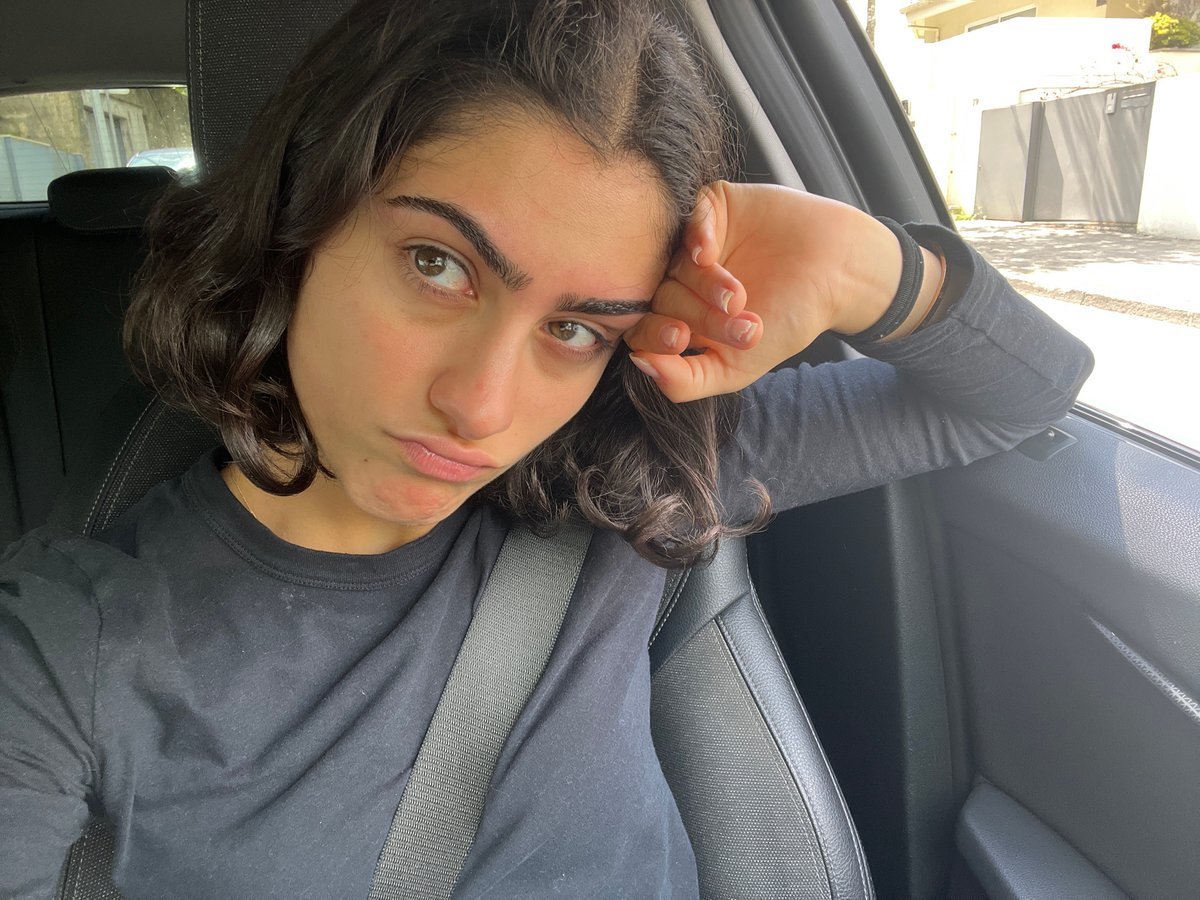 Woman takes selfie in passenger seat, Porto