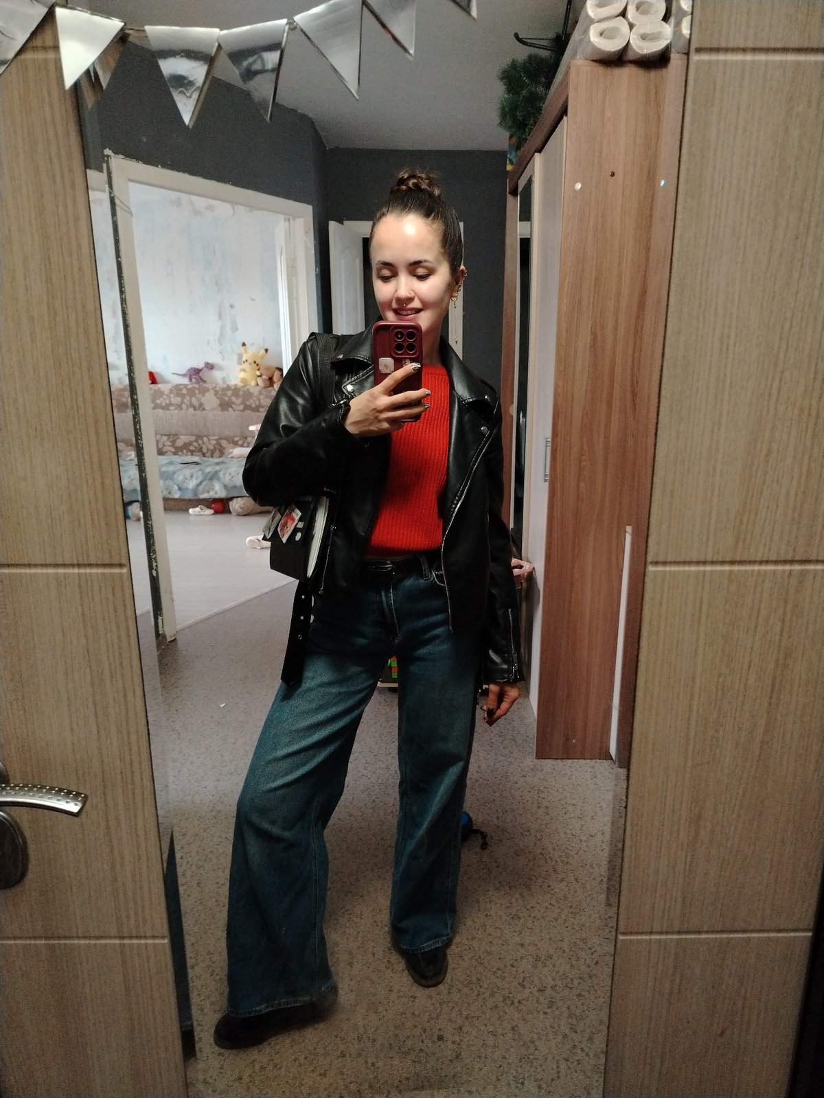 Woman takes mirror selfie in residential space in Noviy