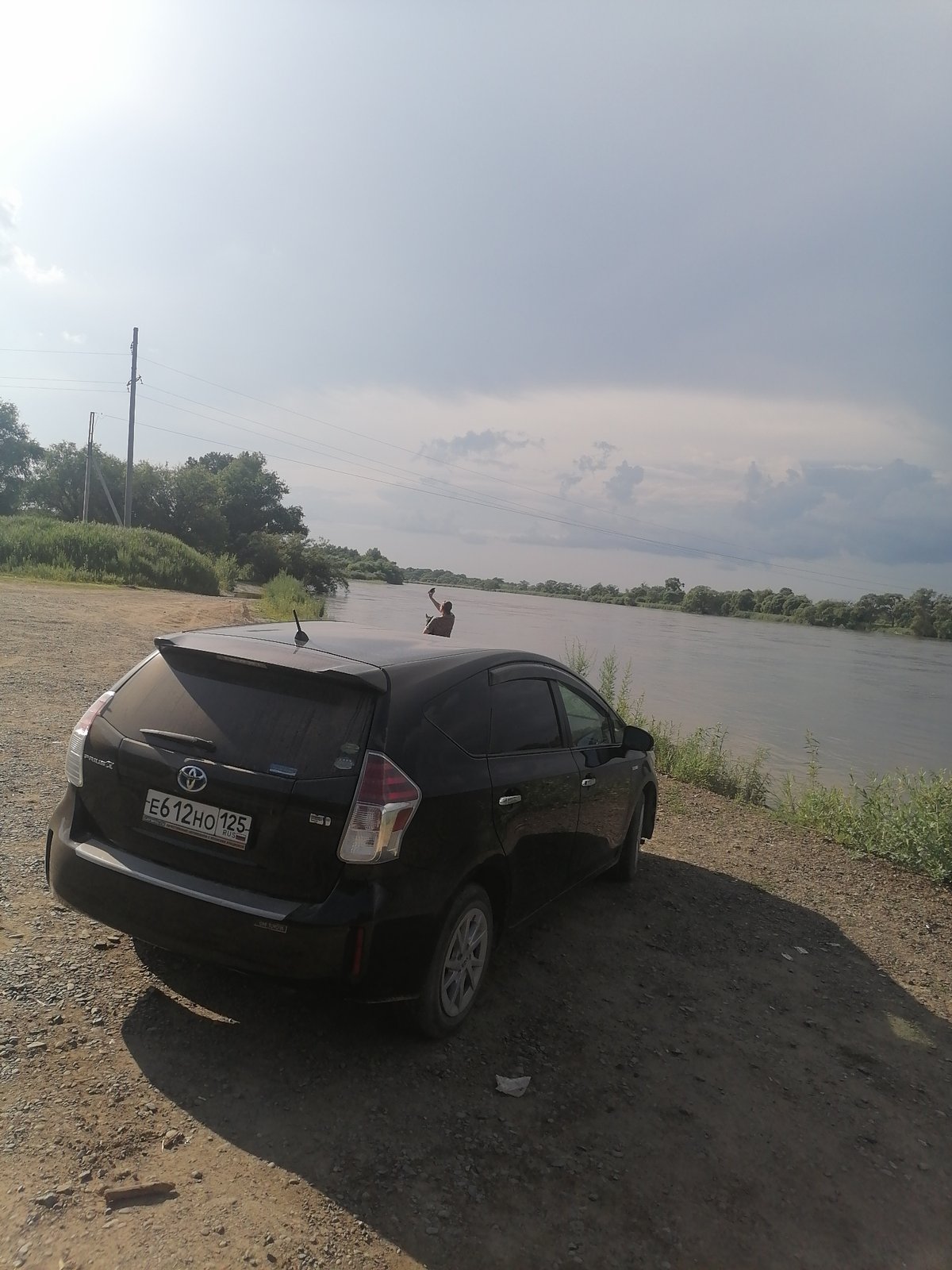 Wooden suspension bridge over a muddy river, Novopokrovka
