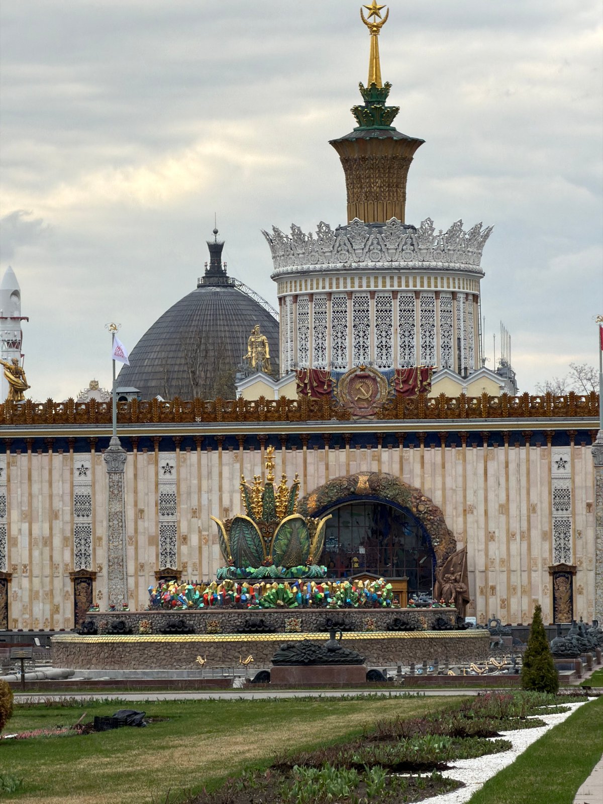 Moscow exhibition pavilions with golden spire captured under overcast sky