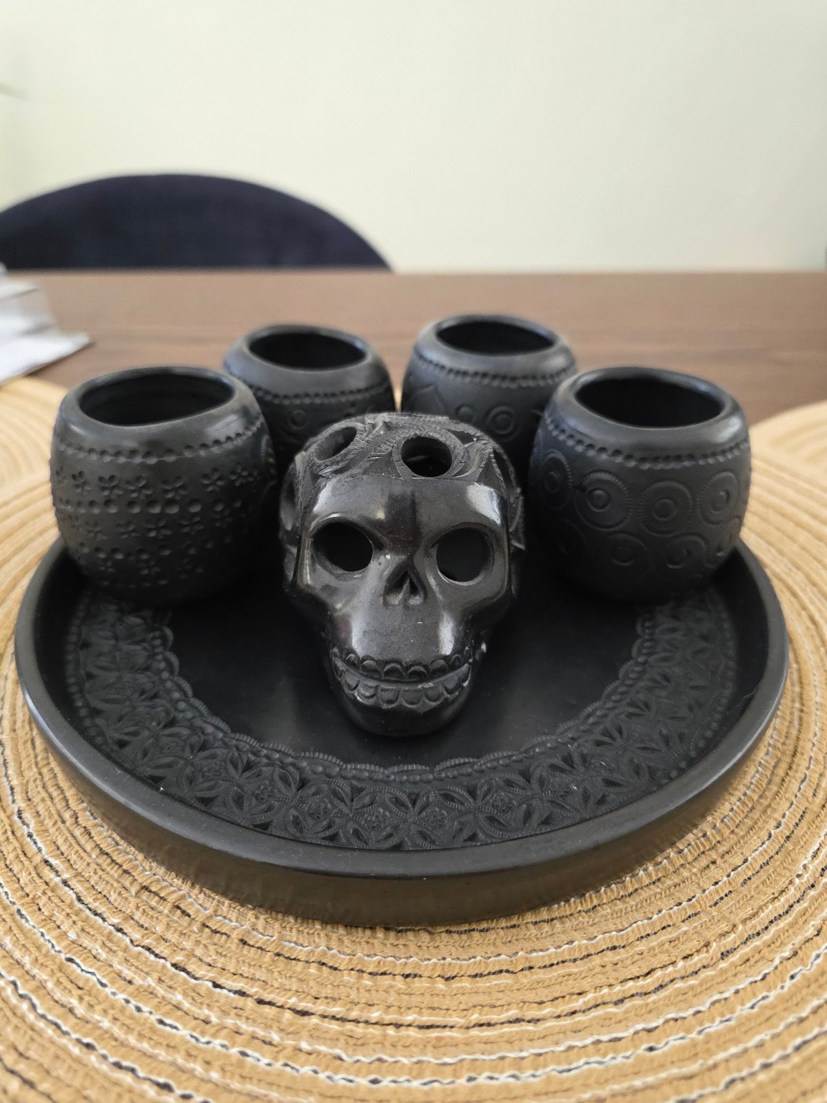 Black ceramic skull and vessels displayed in Puebla home