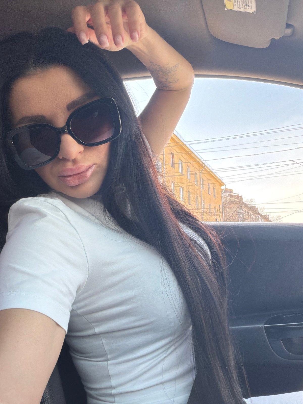 Woman rests in car near construction site in Voronezh