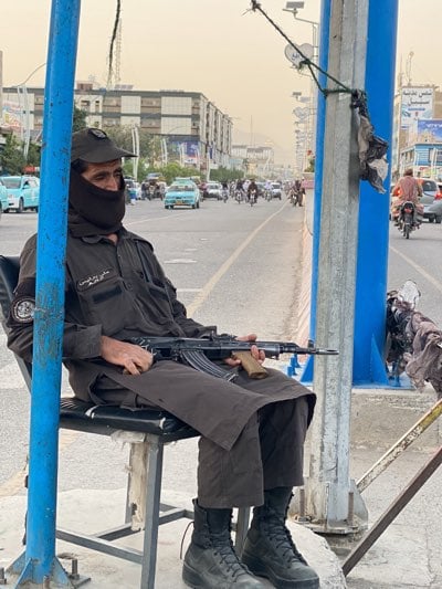 Armed security personnel maintain street posts across Kandahar