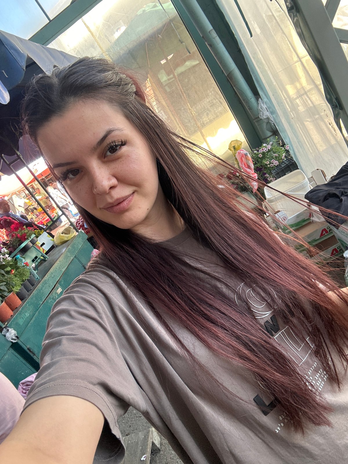 Woman takes morning selfies at Sliven marketplace greenhouse