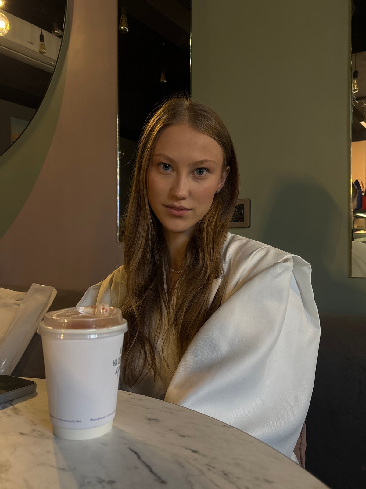 Woman observed at Perm café during afternoon coffee break
