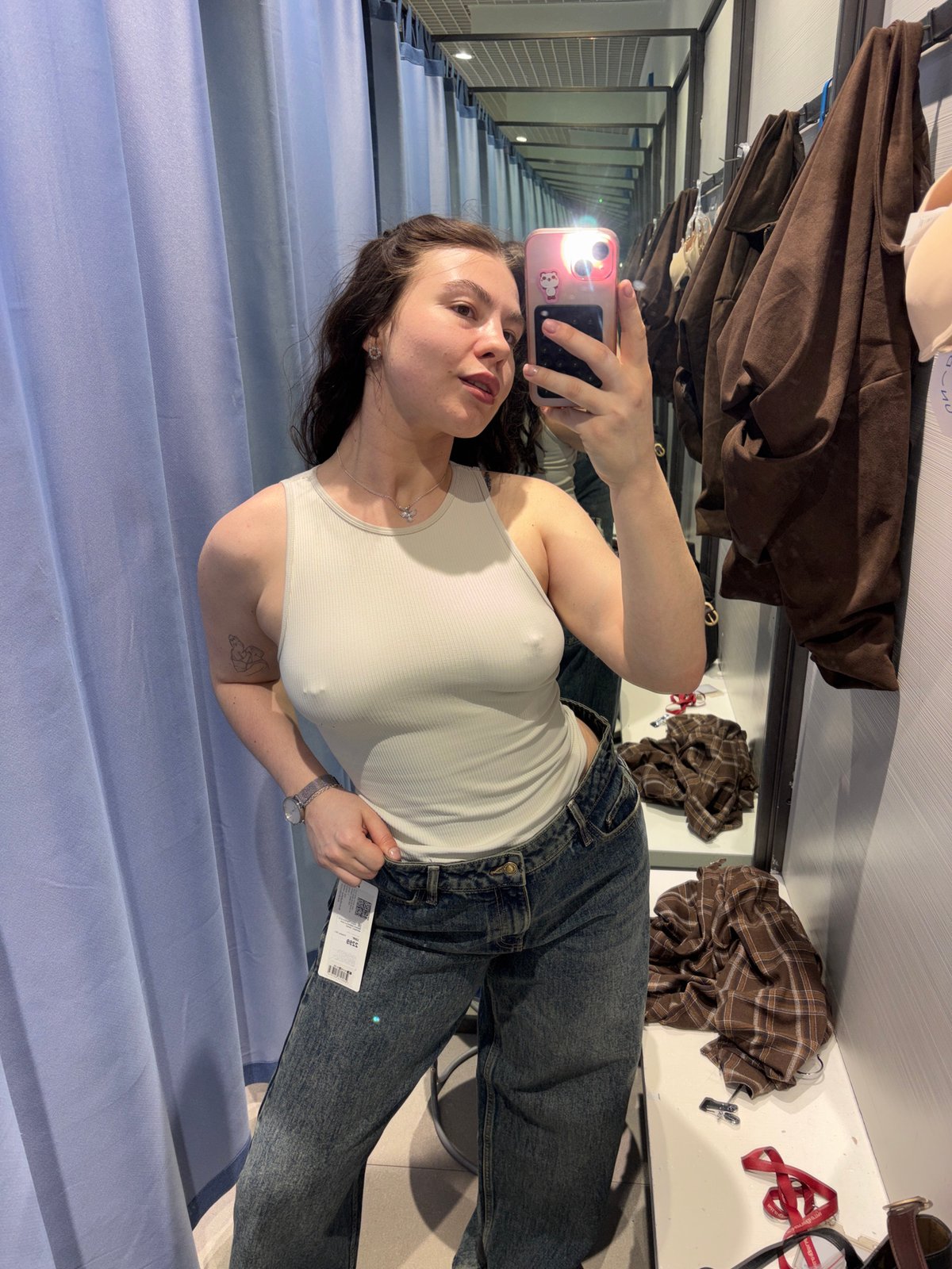 Woman tries on clothes in Perm store fitting room