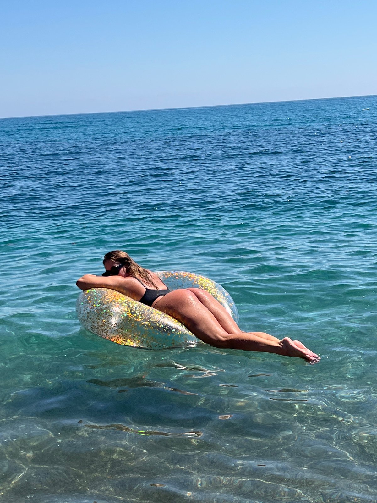 Woman enjoys sunny beach day in Prijevor, Montenegro waters