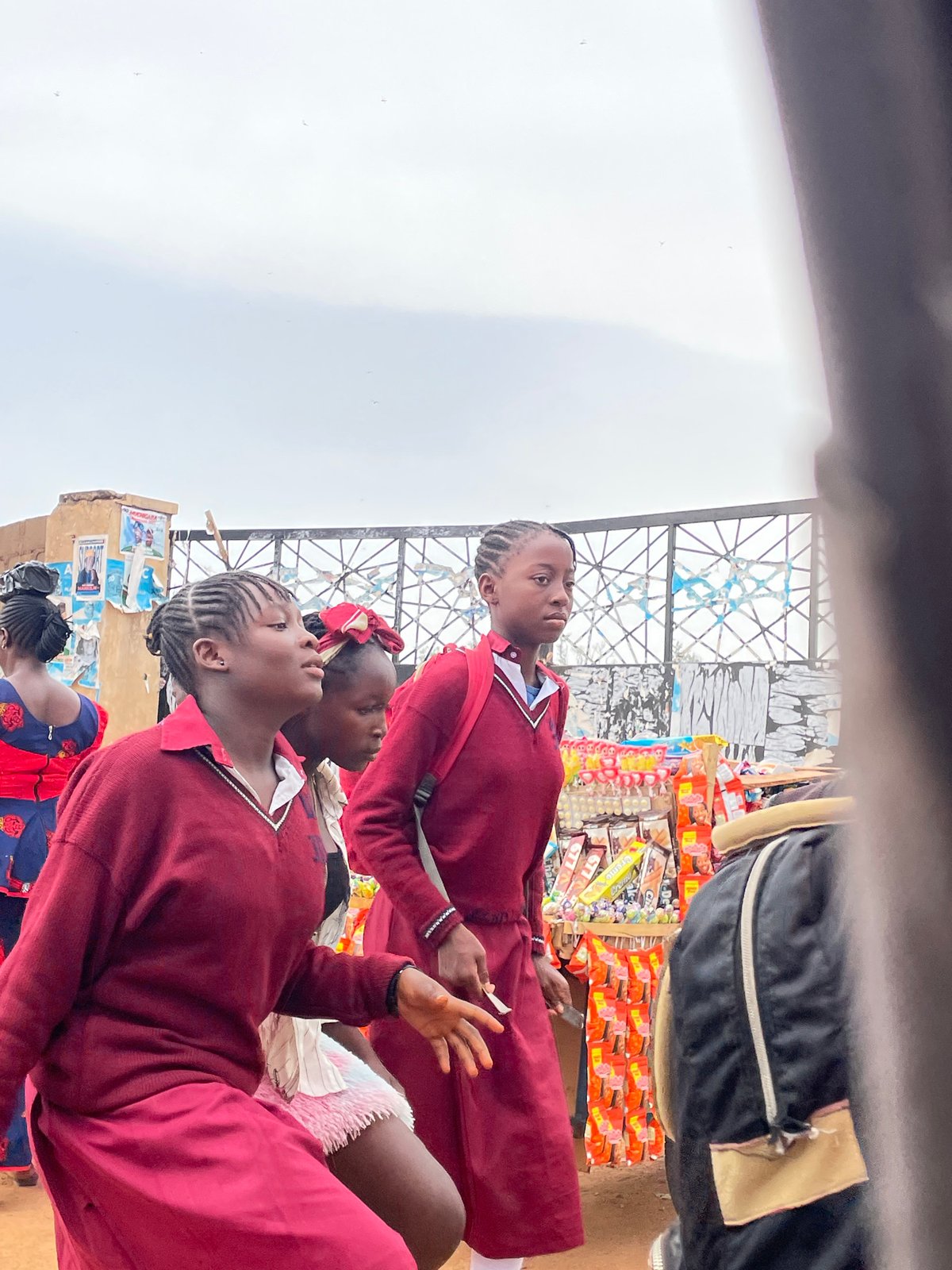 Schoolgirls and man observed in Jos, Nigeria market area