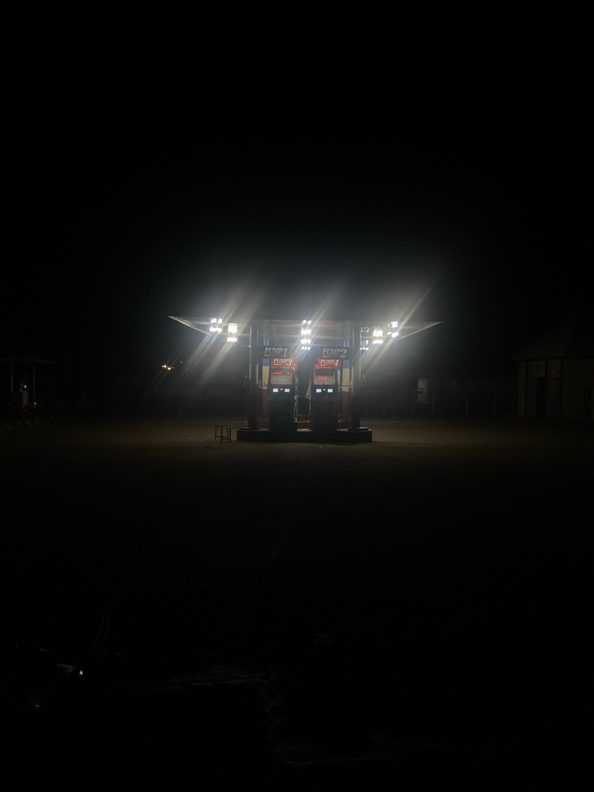 Illuminated gas station observed at night in Nigeria
