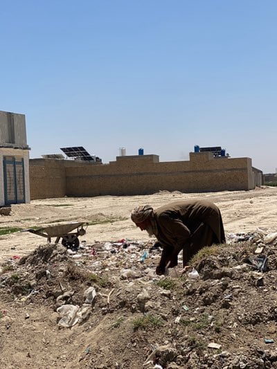 Daily life documented in Kandahar streets, children carrying water