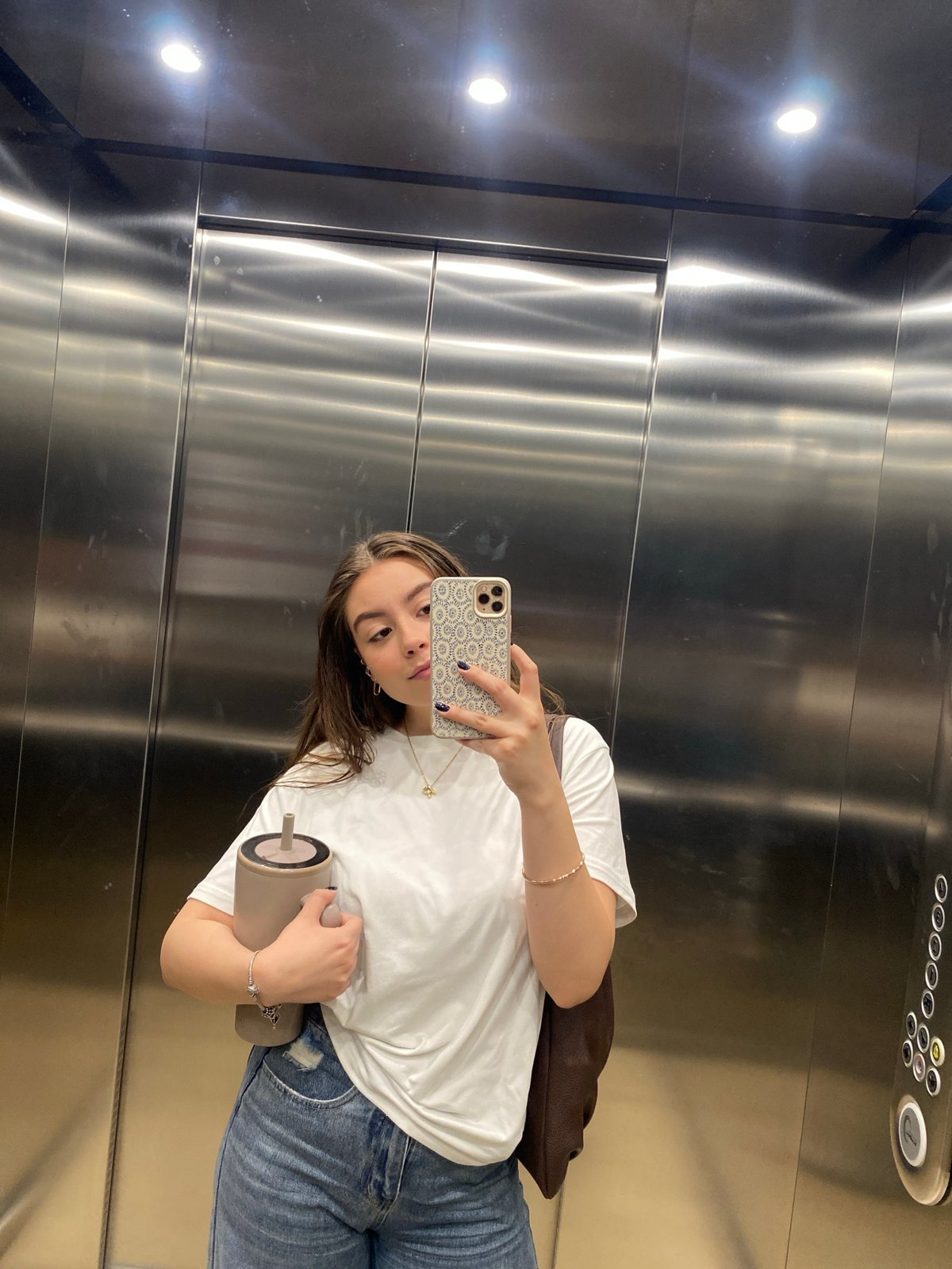 Woman Takes Elevator Selfie at Modern Building