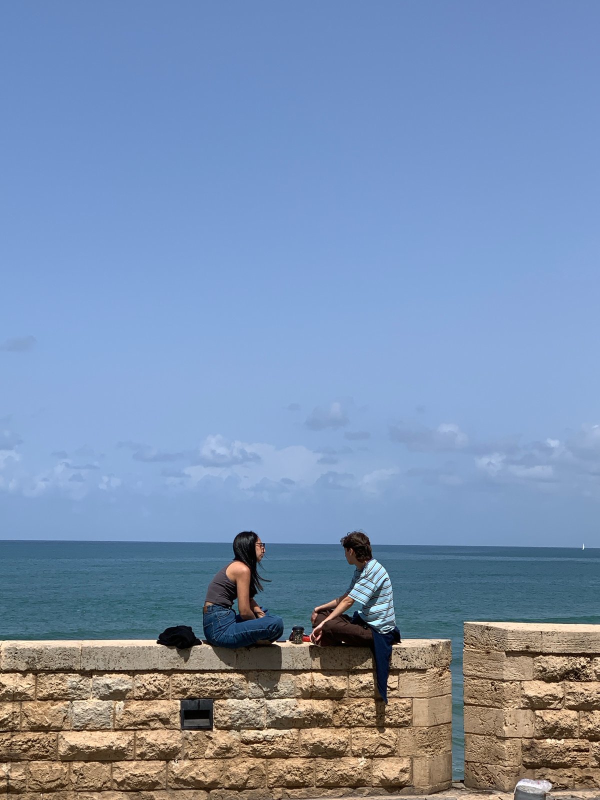 Casual Tel-Aviv moments: oceanside socializing, architecture, broken statue