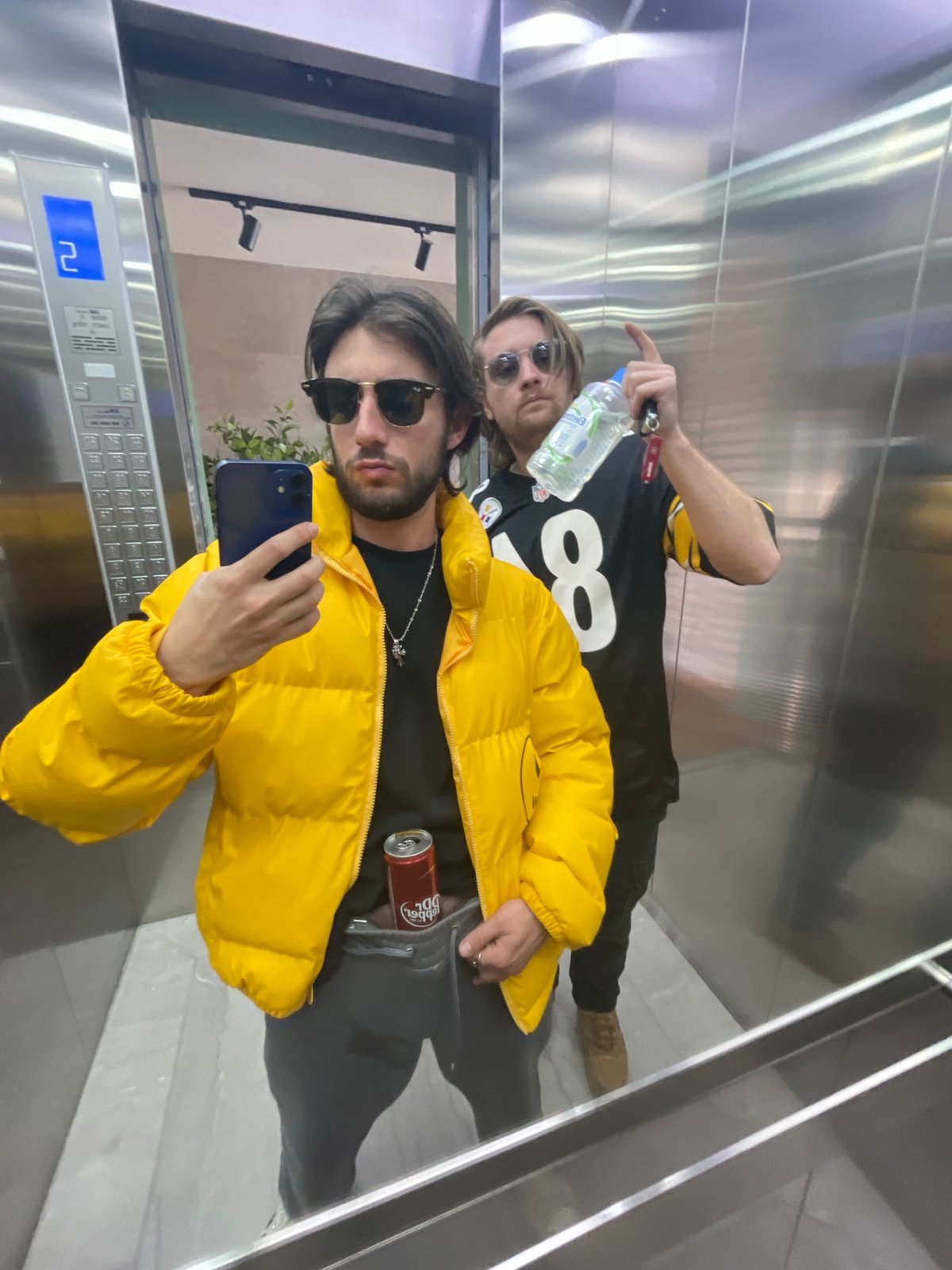 Two men take selfies in Mexico City area buildings