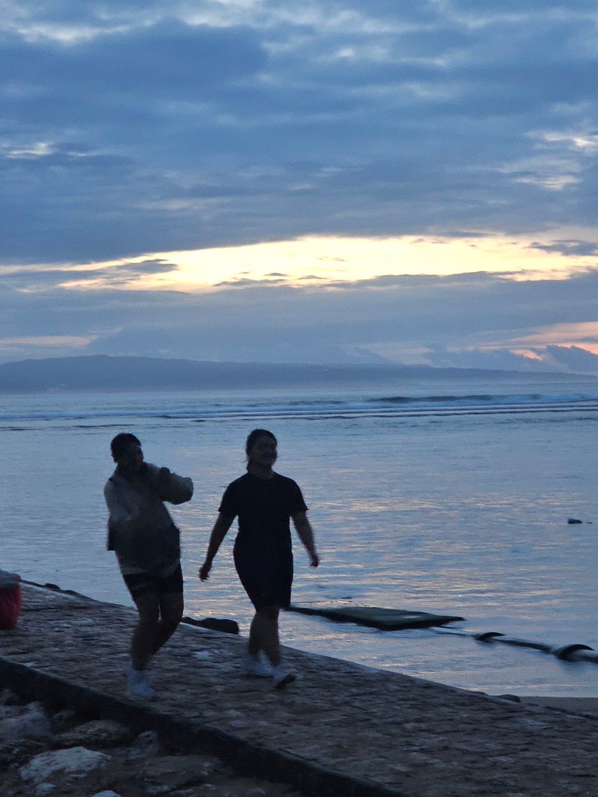 Evening shoreline activities observed in Denpasar, Indonesia