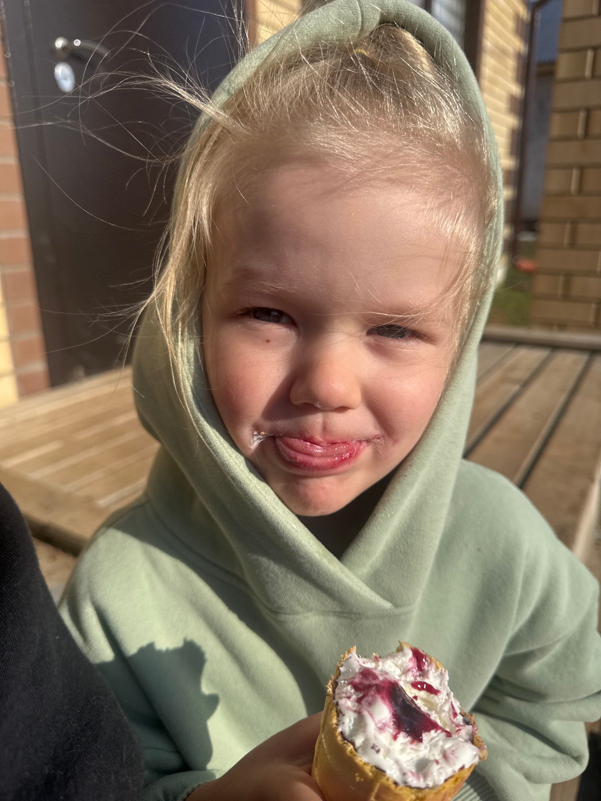 Child enjoys ice cream cone in Russian village