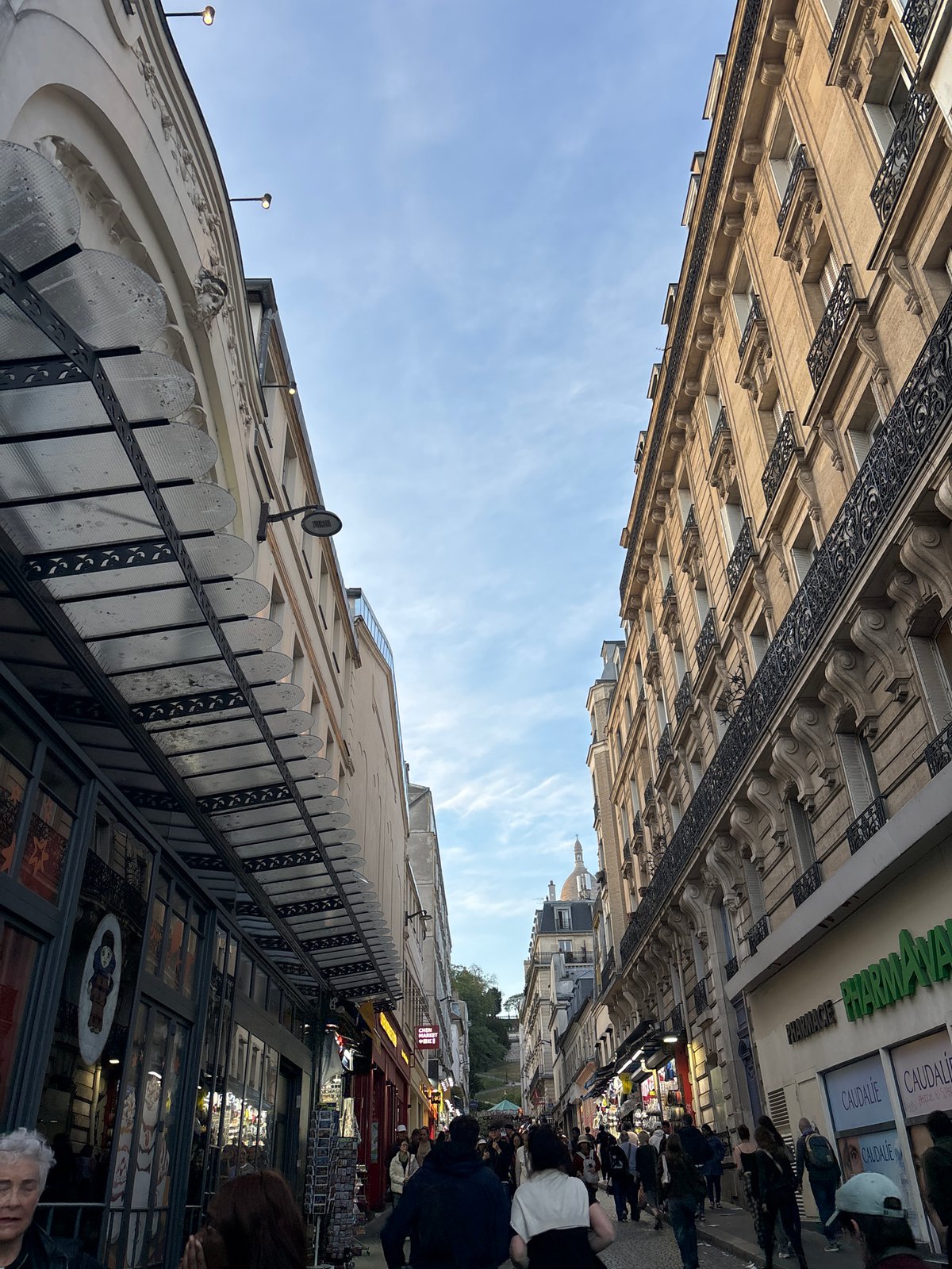 Parisian street scene documented showing classic architecture under blue sky