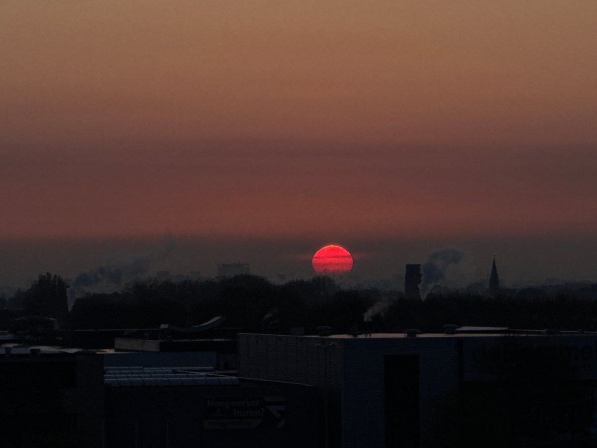Red sunrise captured over Maasdijk Netherlands skyline