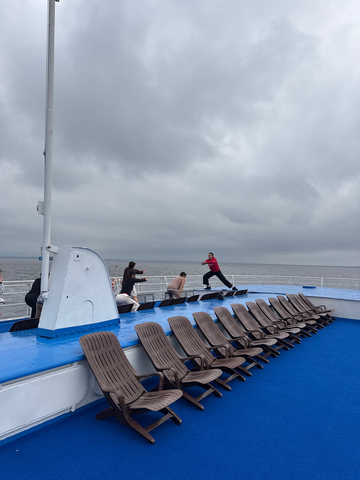 Workout session on a Russian ferry deck under cloudy skies