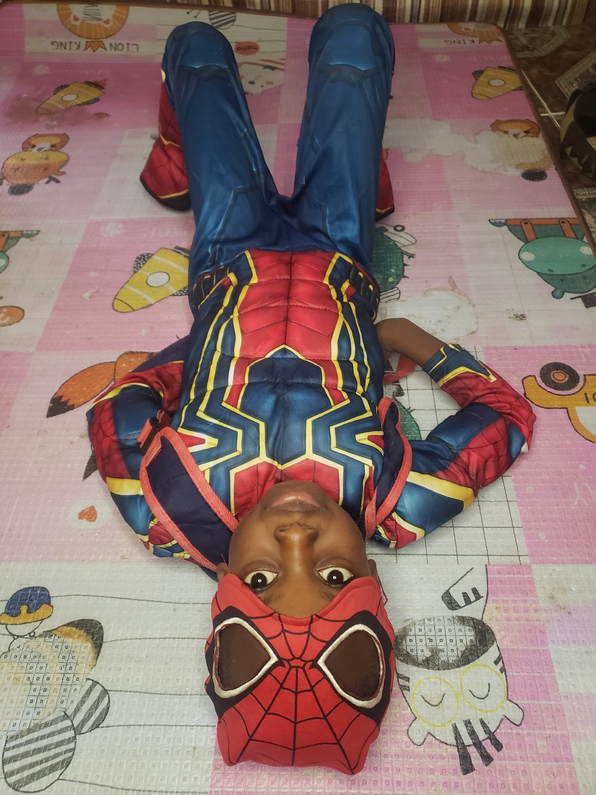 Spider-Man costume fully committed to in a Narayi living room