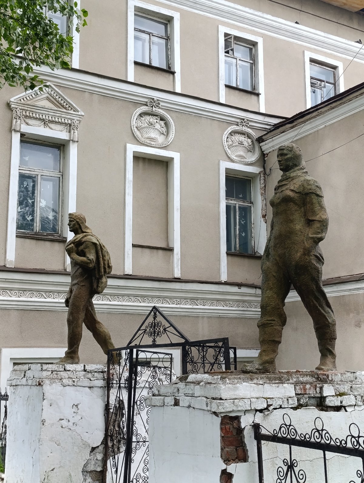 Weathered statues observed on crumbling base in Tara, Russia