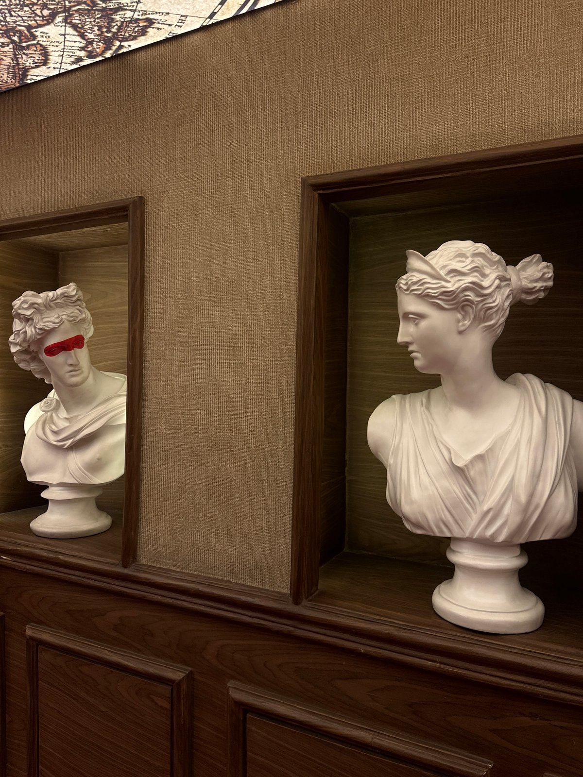 Man interacts with classical busts in Nigerian indoor display