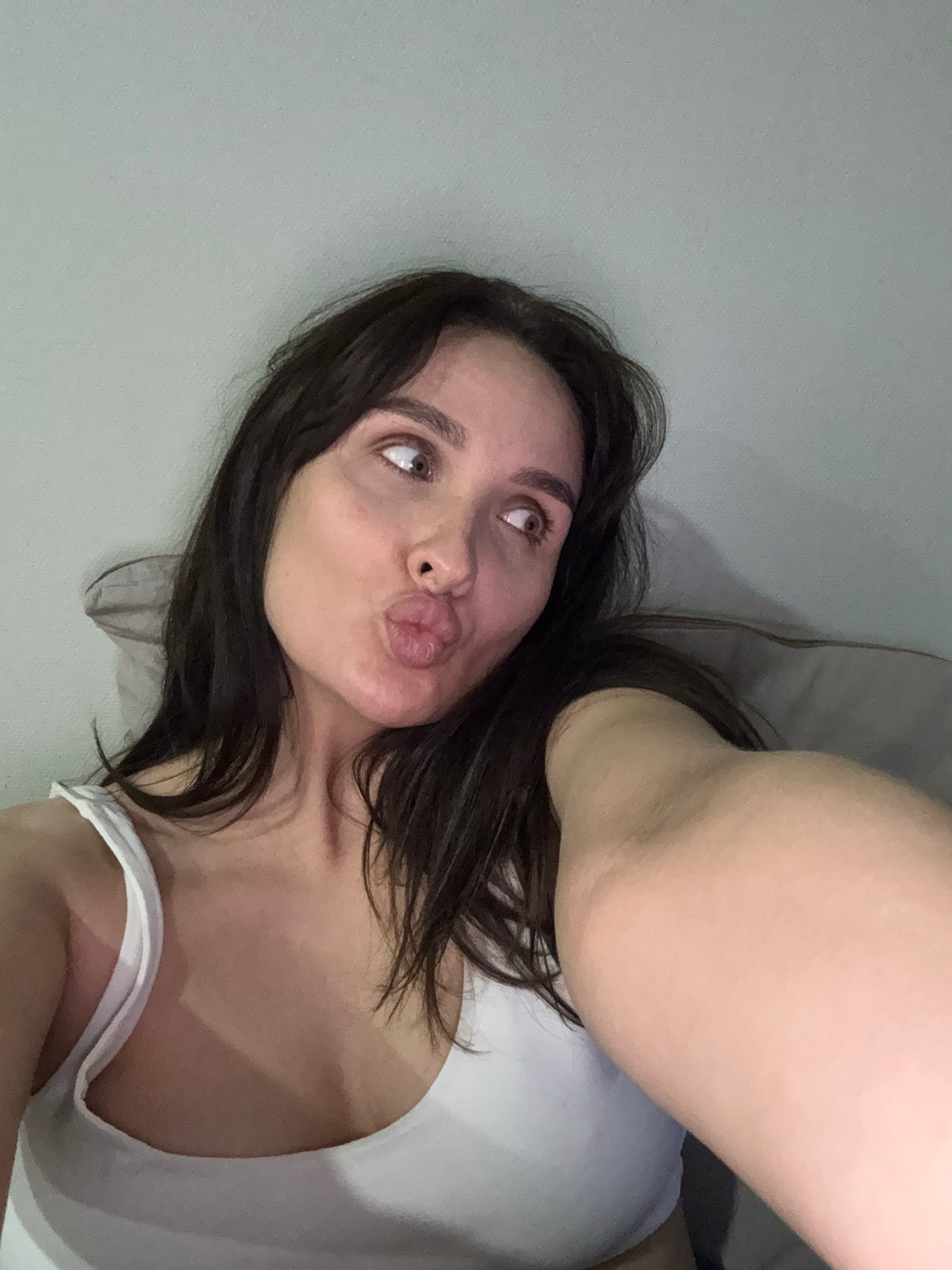 Woman takes selfies in bedroom during morning in Chaikovsky