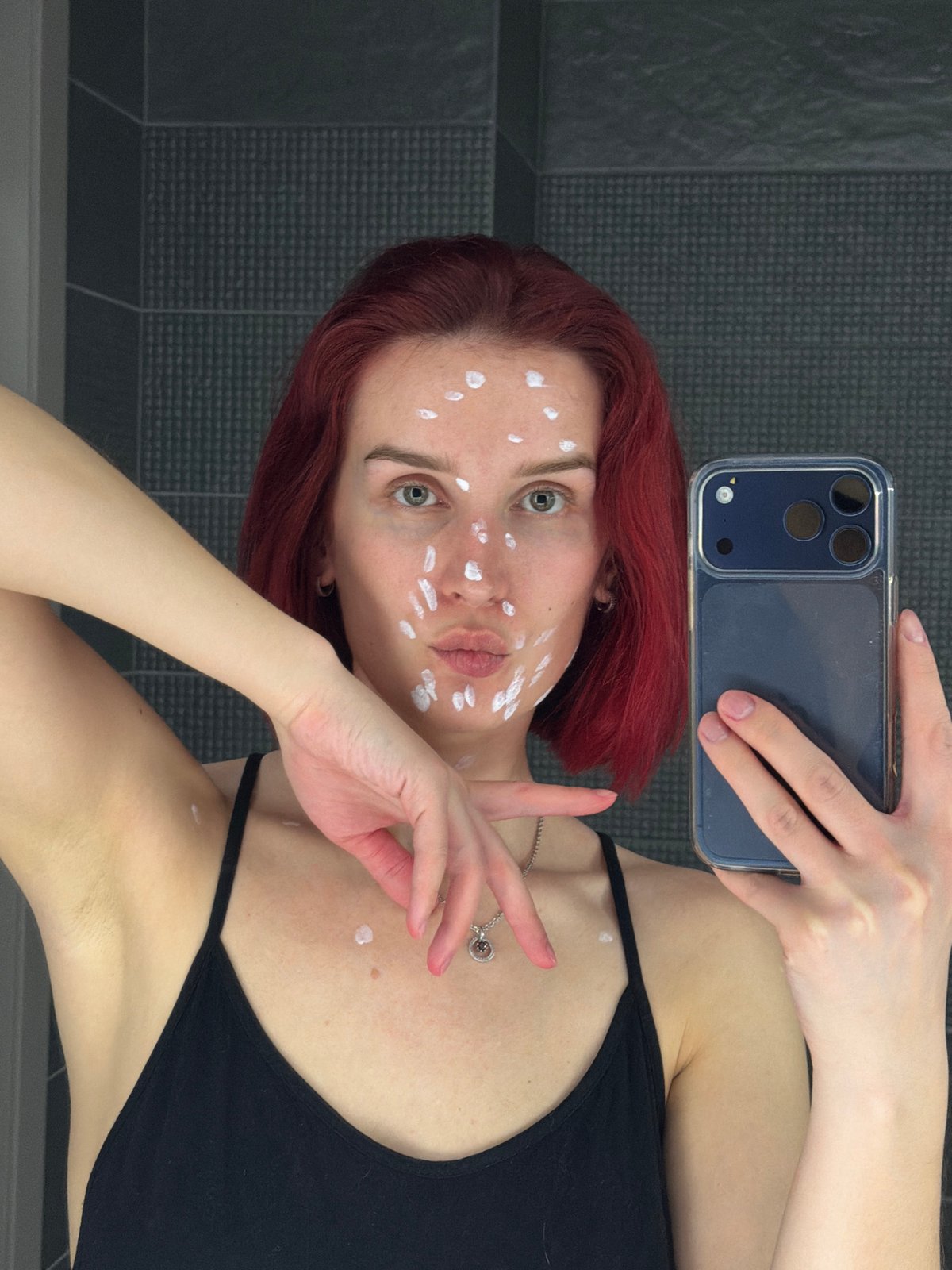 Woman Takes Bathroom Selfies While Applying Face Treatment