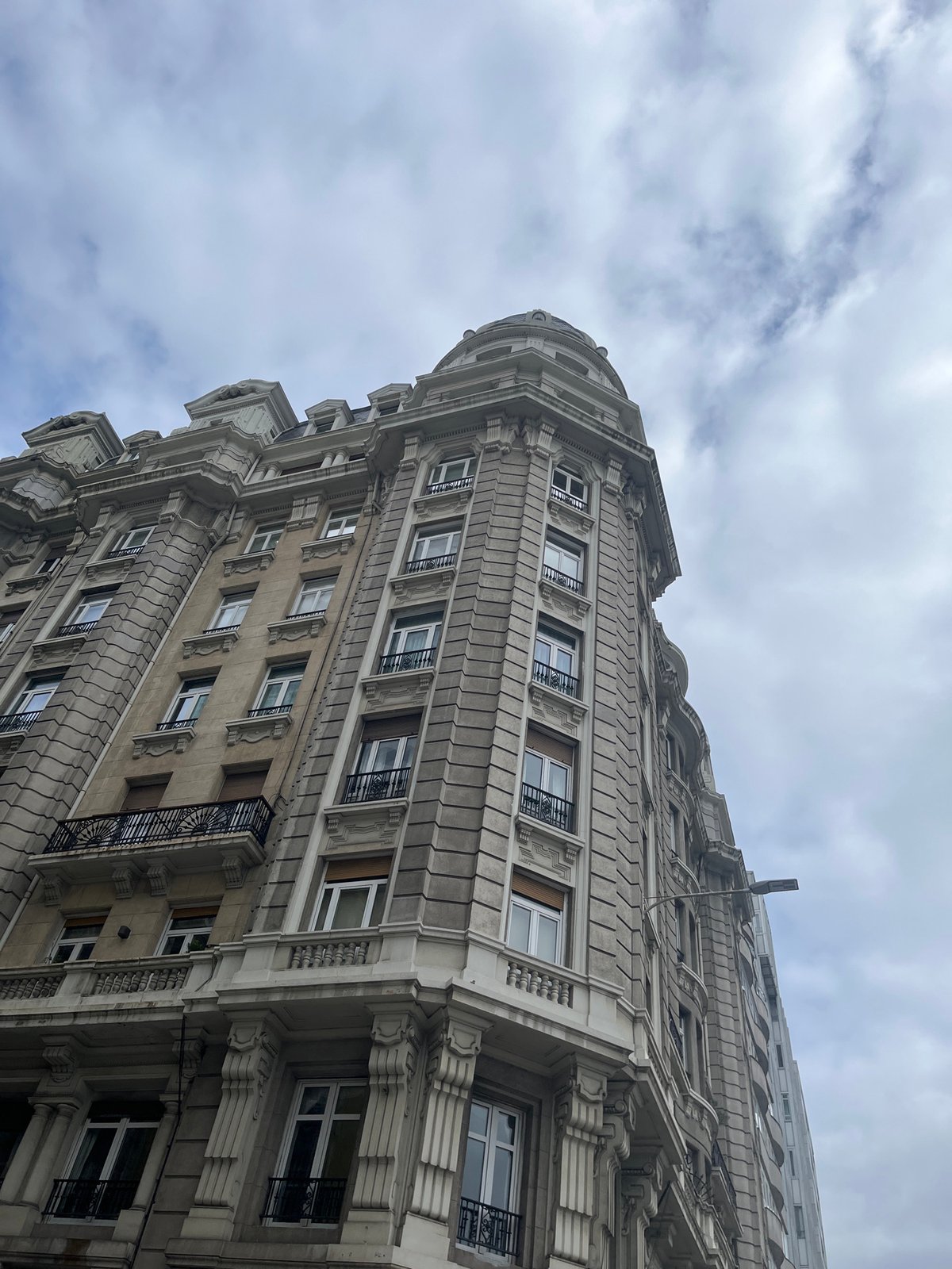 Ornate building photographed from below in A Coruña, Spain