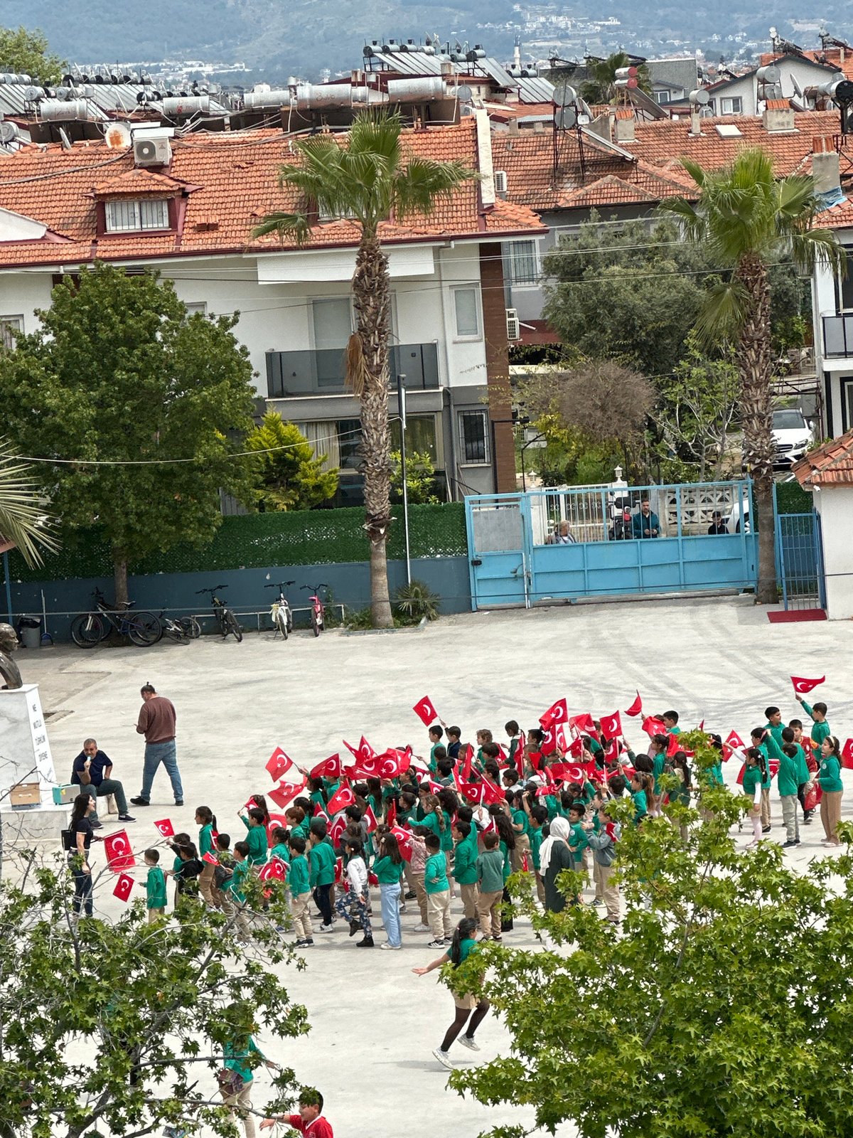 Students hold Turkish flags during school event in Fethiye