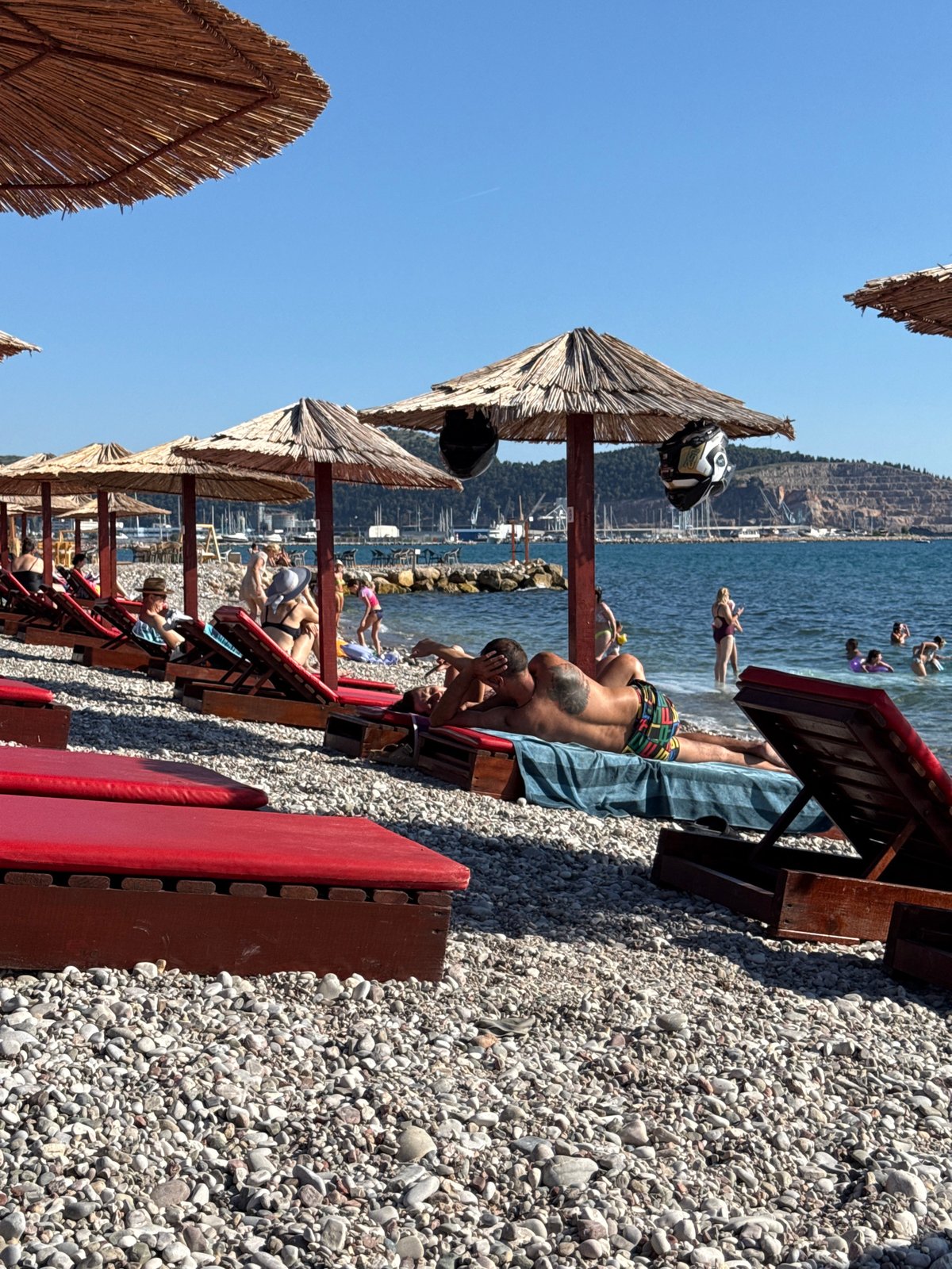 Sunny afternoon on a pebble beach in Bar, Montenegro