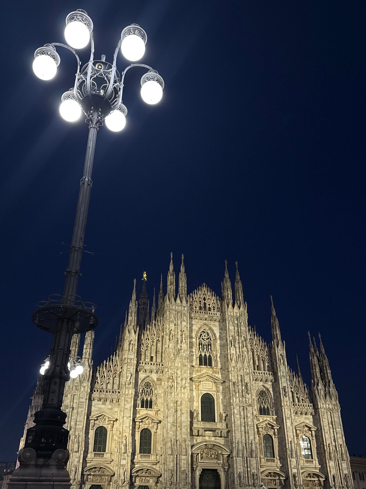 Evening photography session captures illuminated Milan Duomo cathedral