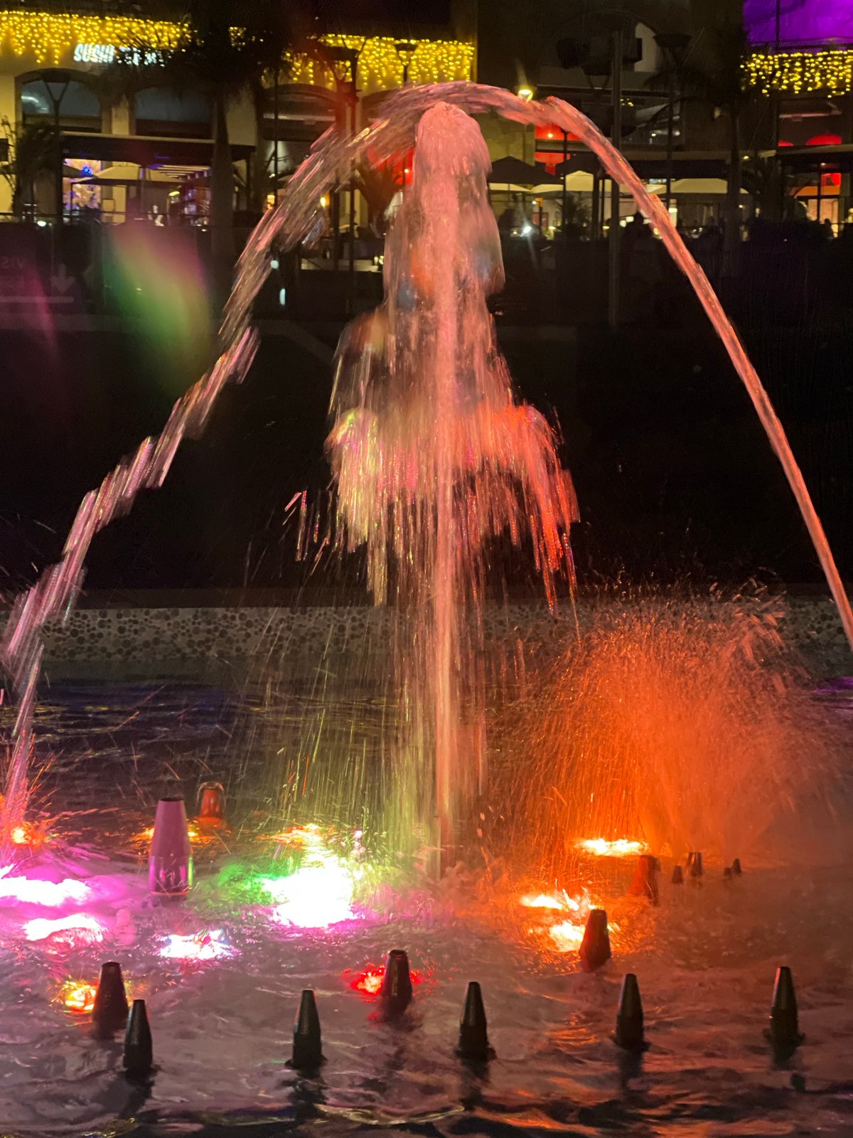 Colorful illuminated fountains light up Spanish resort town