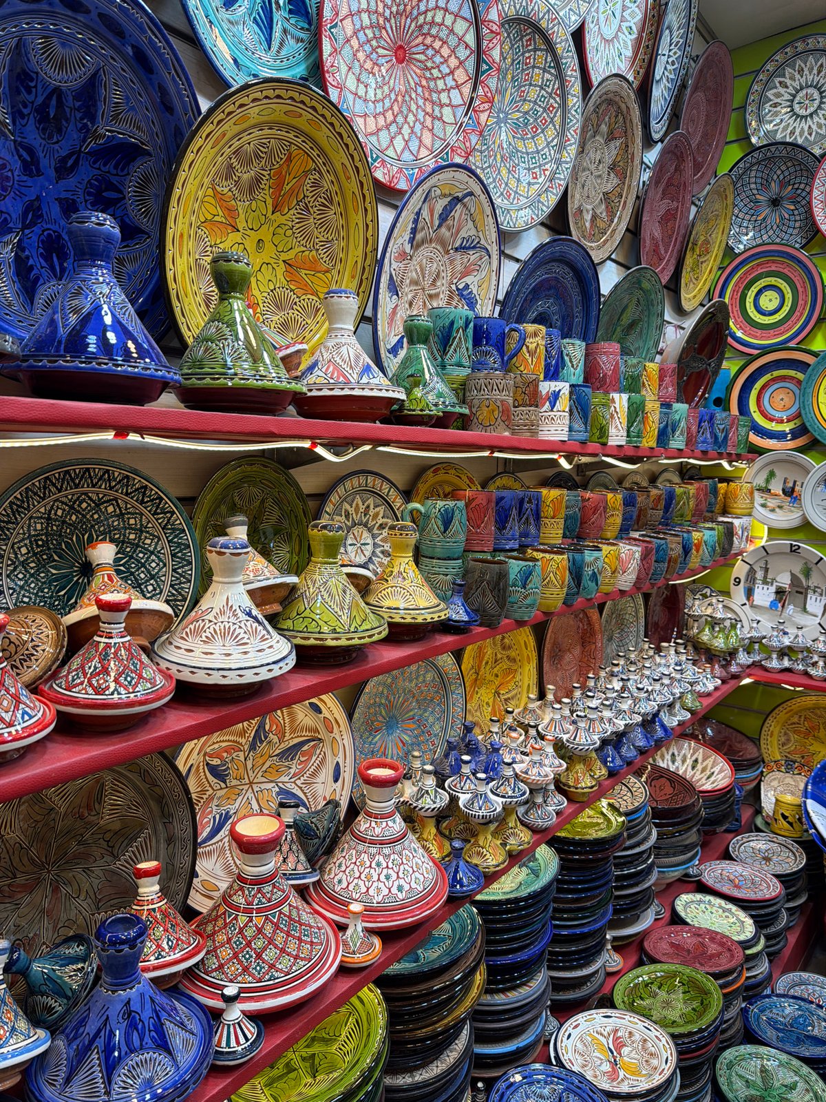 Tourists browse busy market stalls in Marrakesh thoroughfare