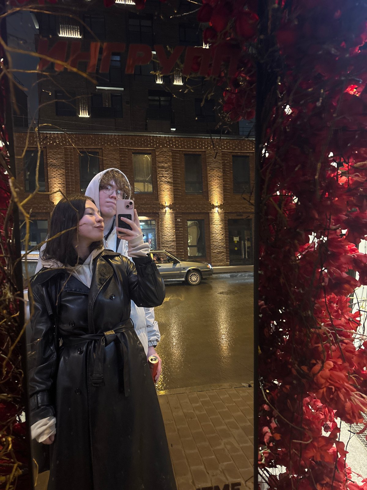 Two people photographed in reflection on wet surface in Perm