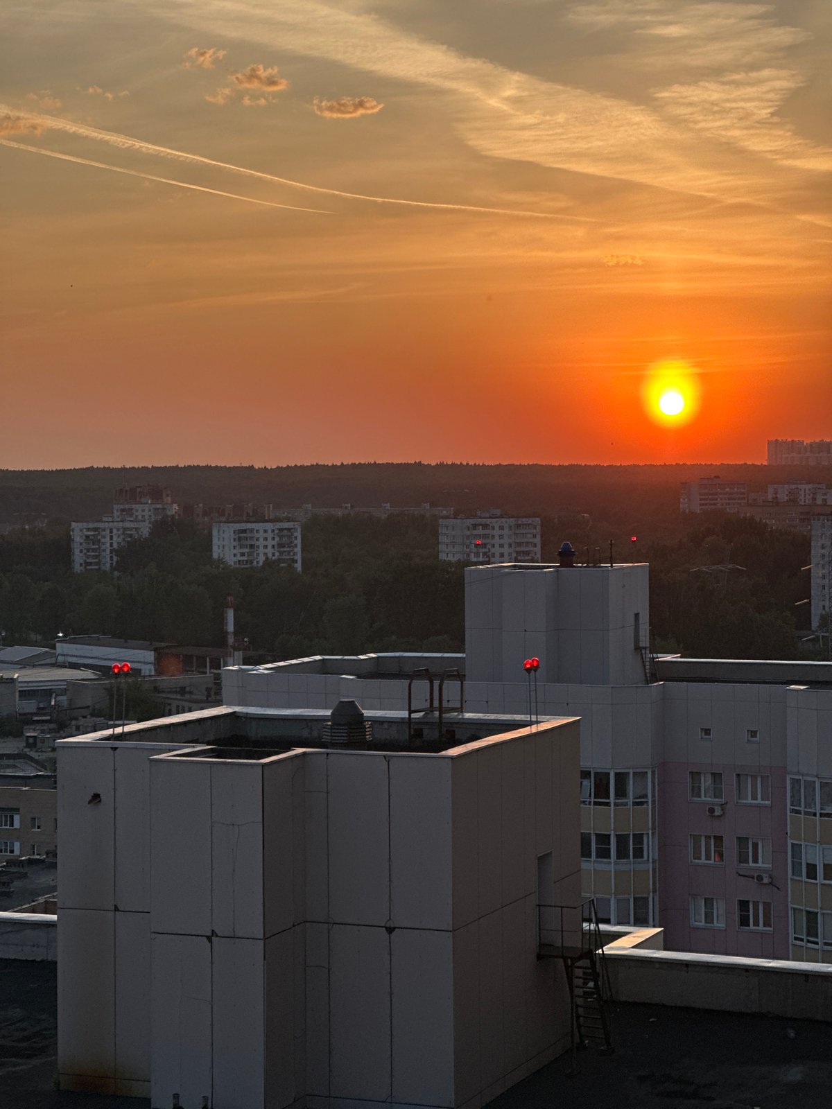 Sunset observed over Zhukovka cityscape with orange skies