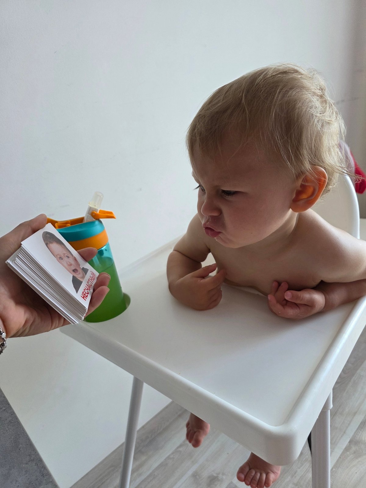 Toddler learns facial expressions through flashcards in Sochi home