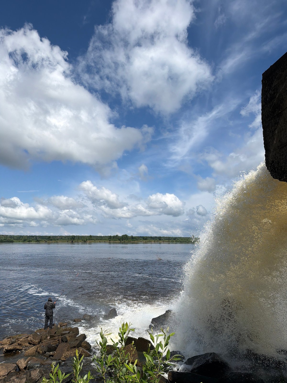 Morning scenes along Olkhovka river with wildflowers and waterfall