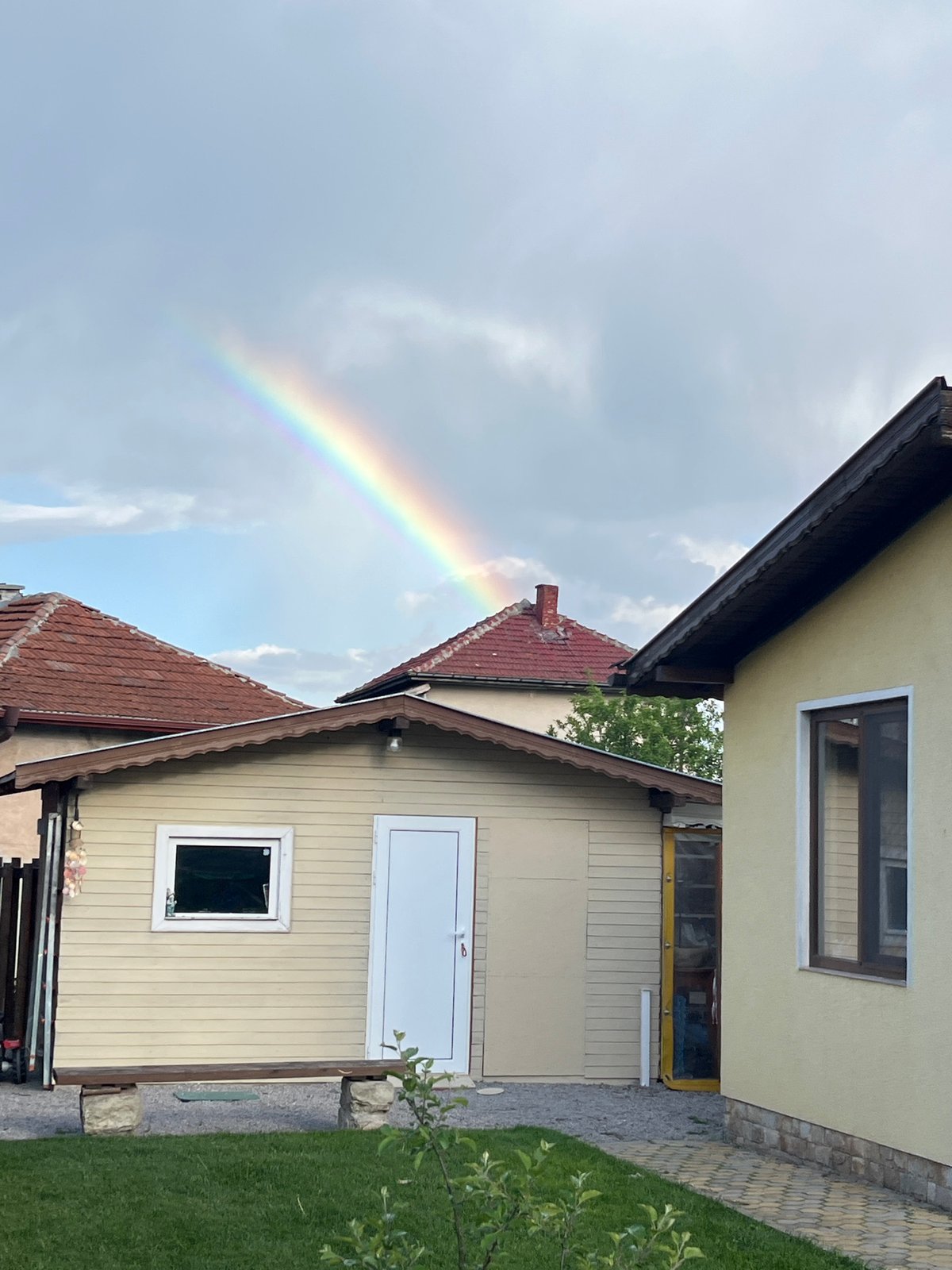 Rainbow arcs over residential neighborhood in Kostinbrod, Bulgaria