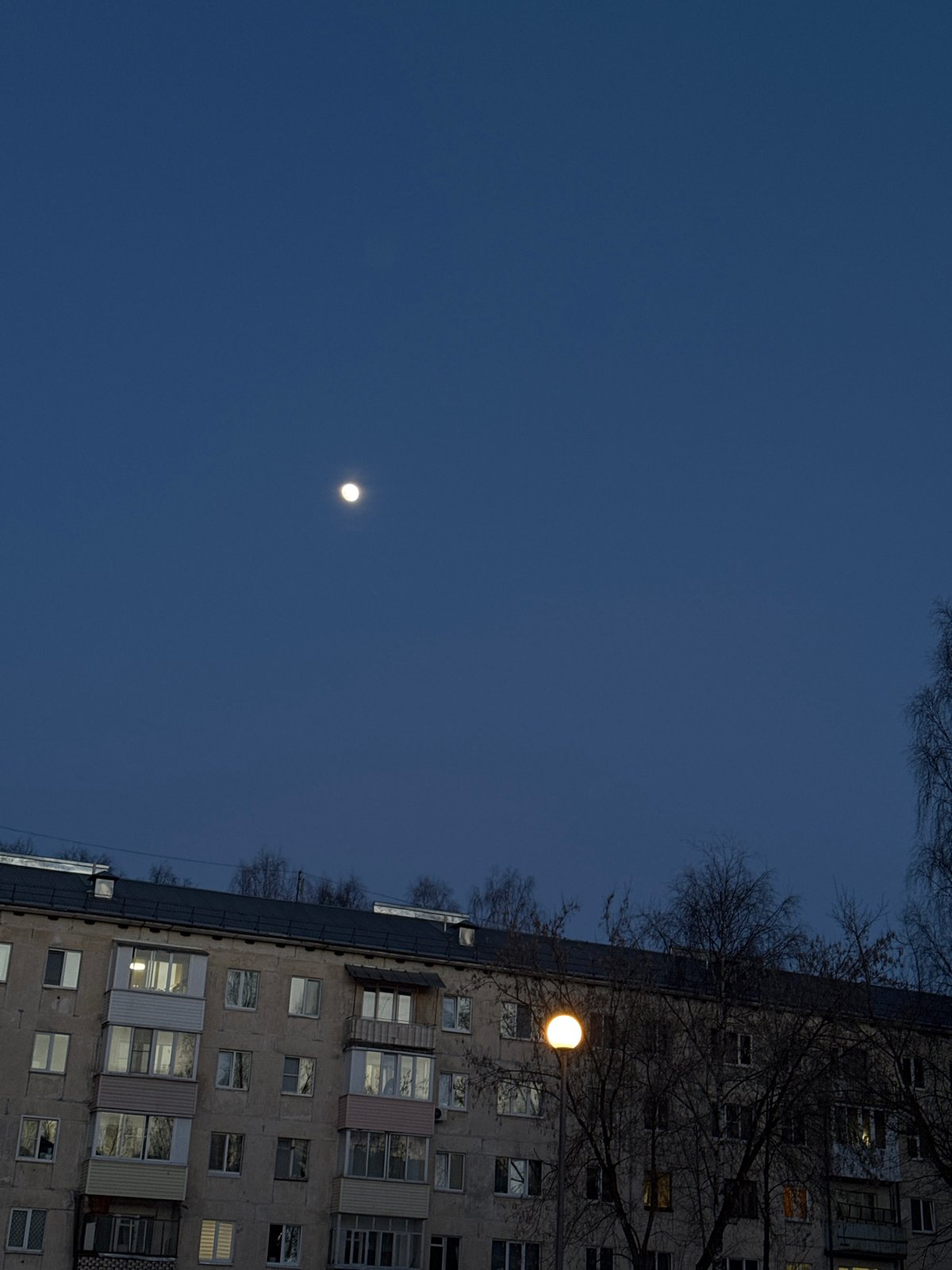 Nighttime apartment building illuminated by street lighting in Izhevsk