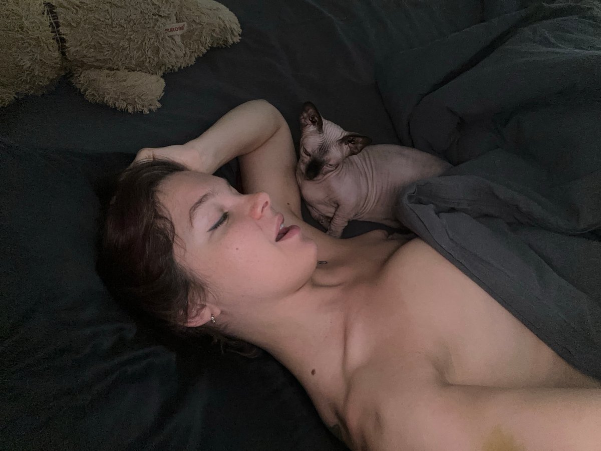 Woman rests with Sphynx cat in Vladimir bedroom