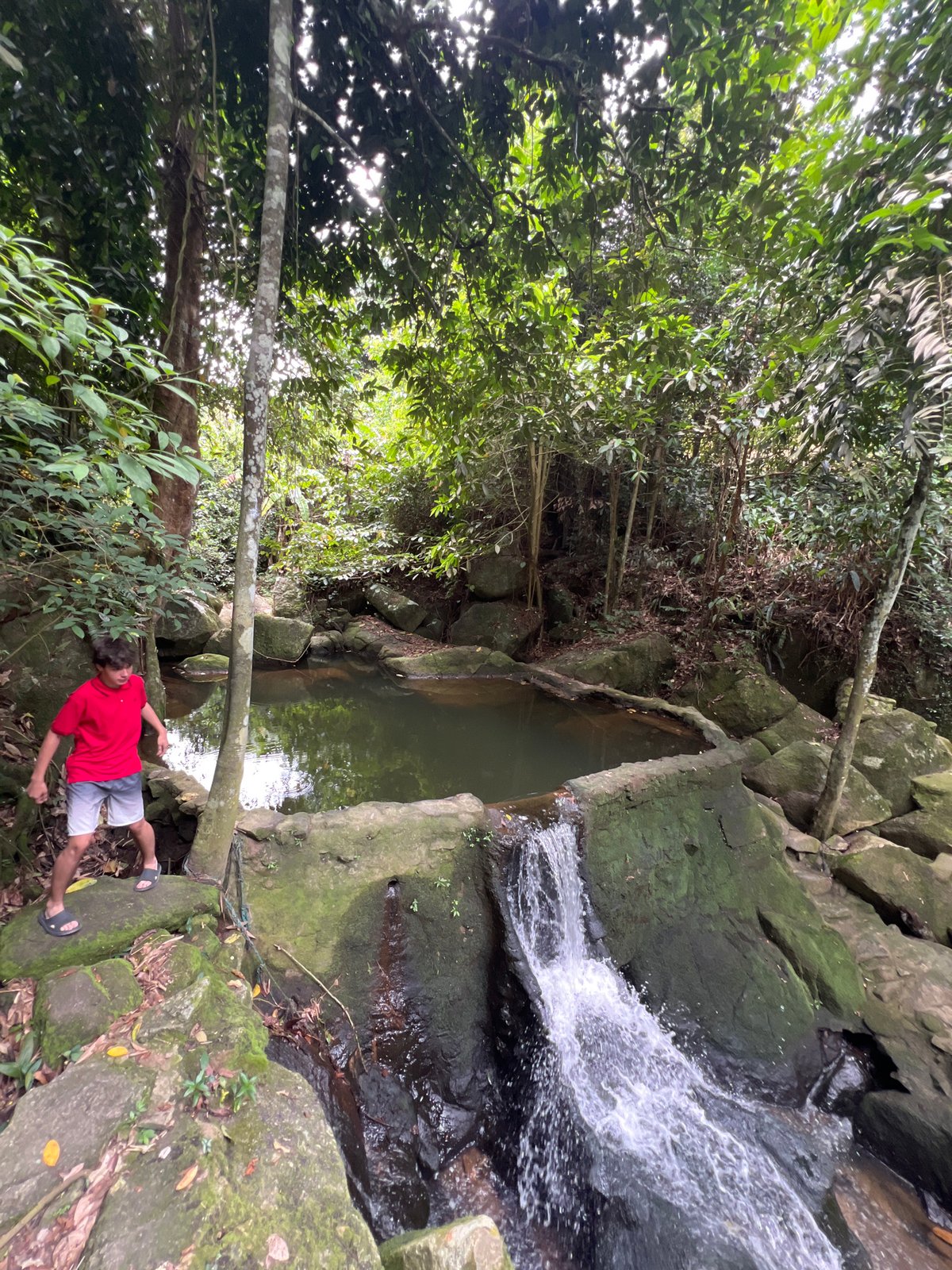 Safari tour group explores a jungle waterfall and ruins on Ko Samui