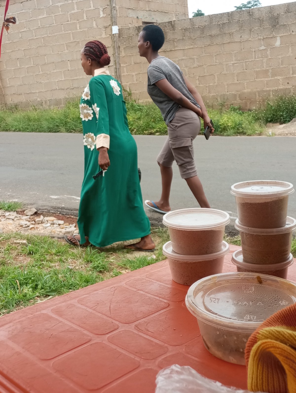 Busy street life along a Jos, Nigeria road on an overcast morning