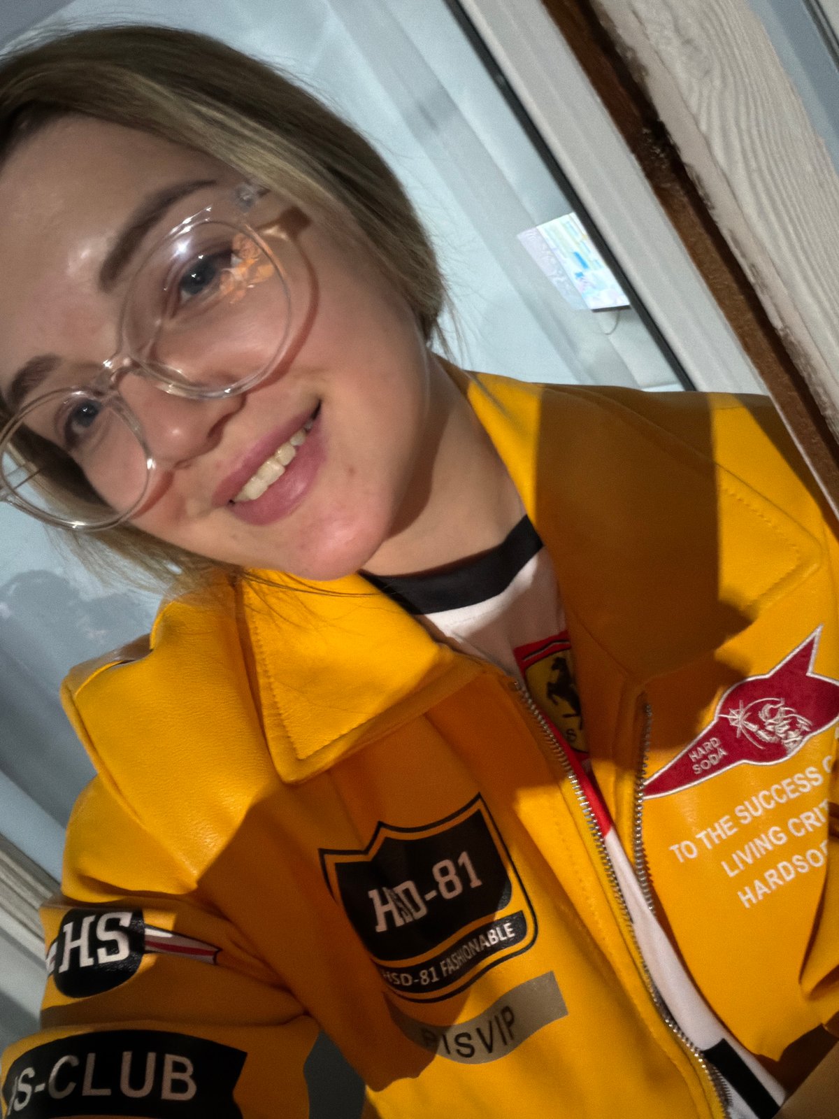 Woman in patched yellow jacket photographed in Kazan evening