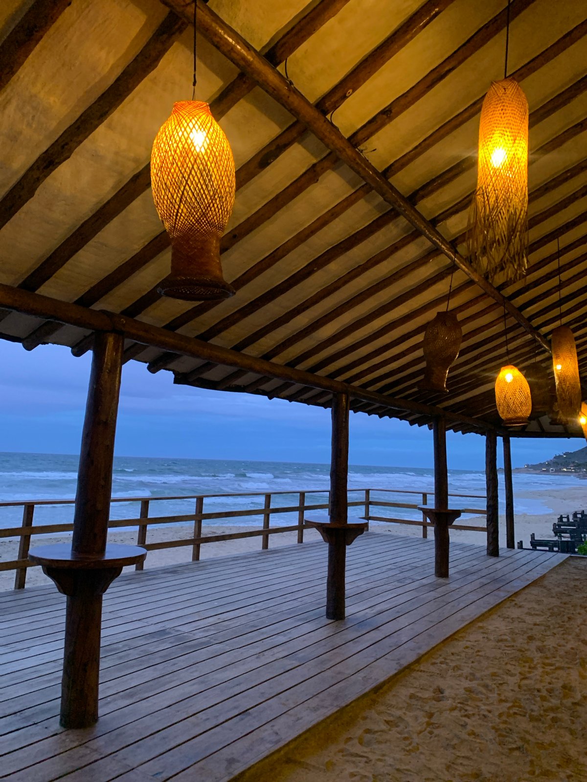 Dusk at a thatched beachside spot in El Tirano, Venezuela