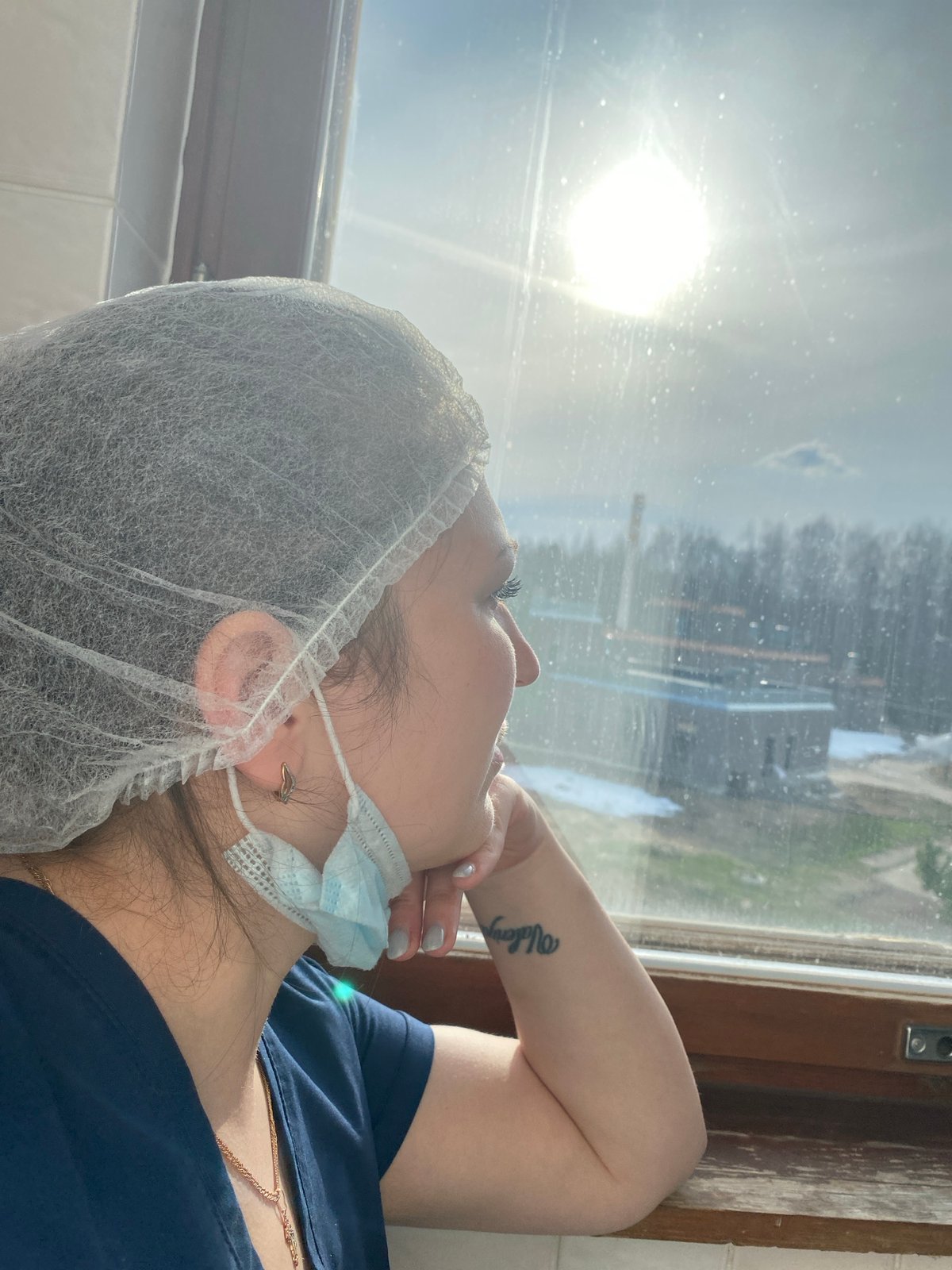 Daily life captured in Марковский: masked woman, Soviet-era building