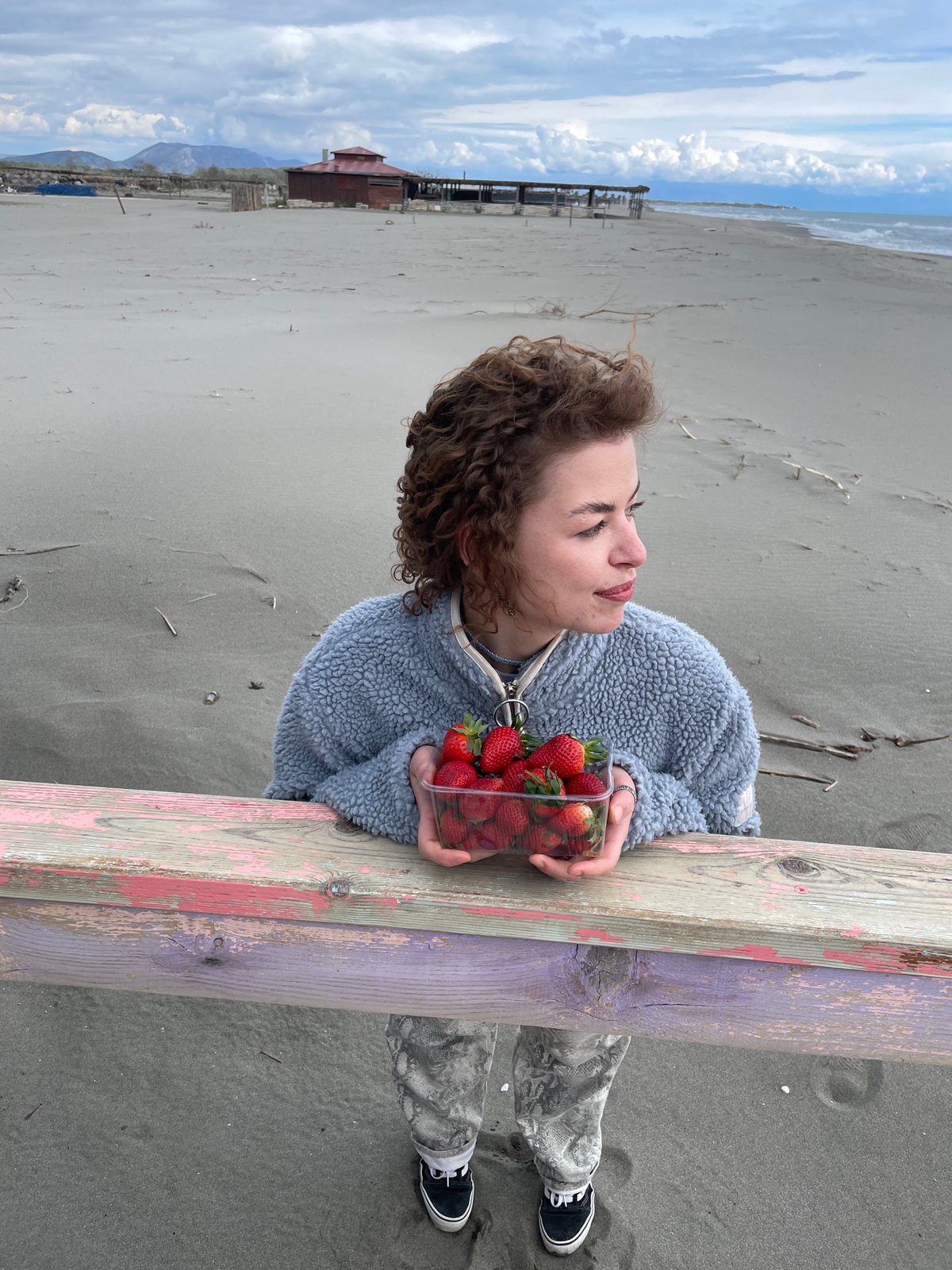 Woman enjoys beach day with strawberries in Montenegro