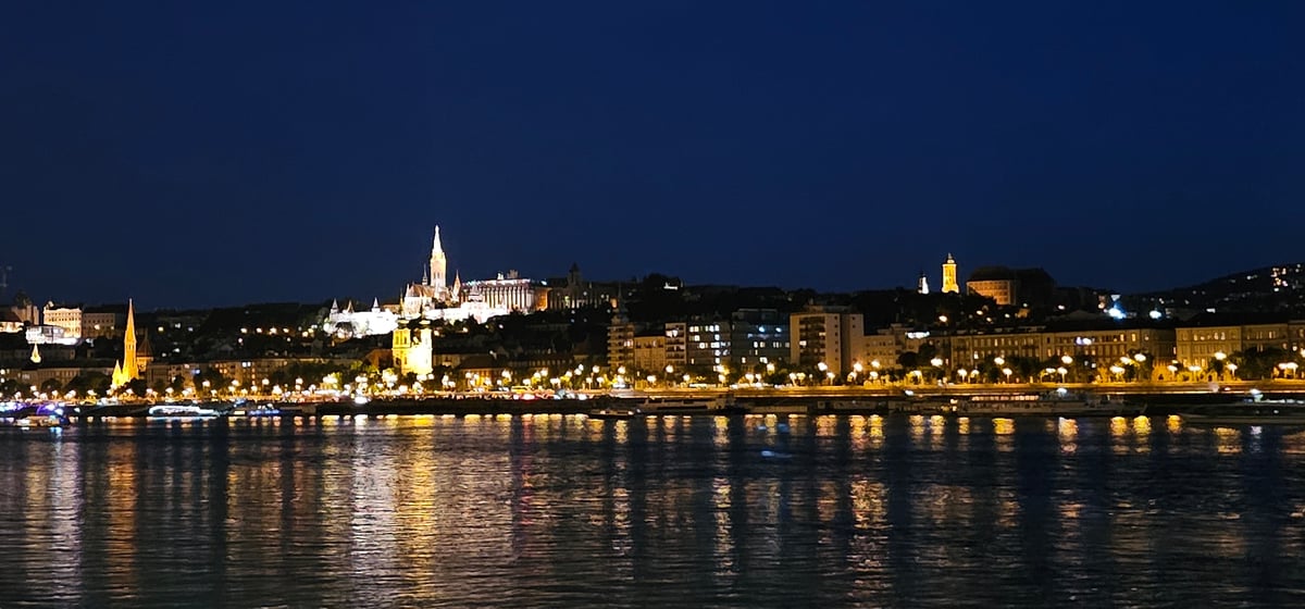 Budapest skyline glows across the Danube at night